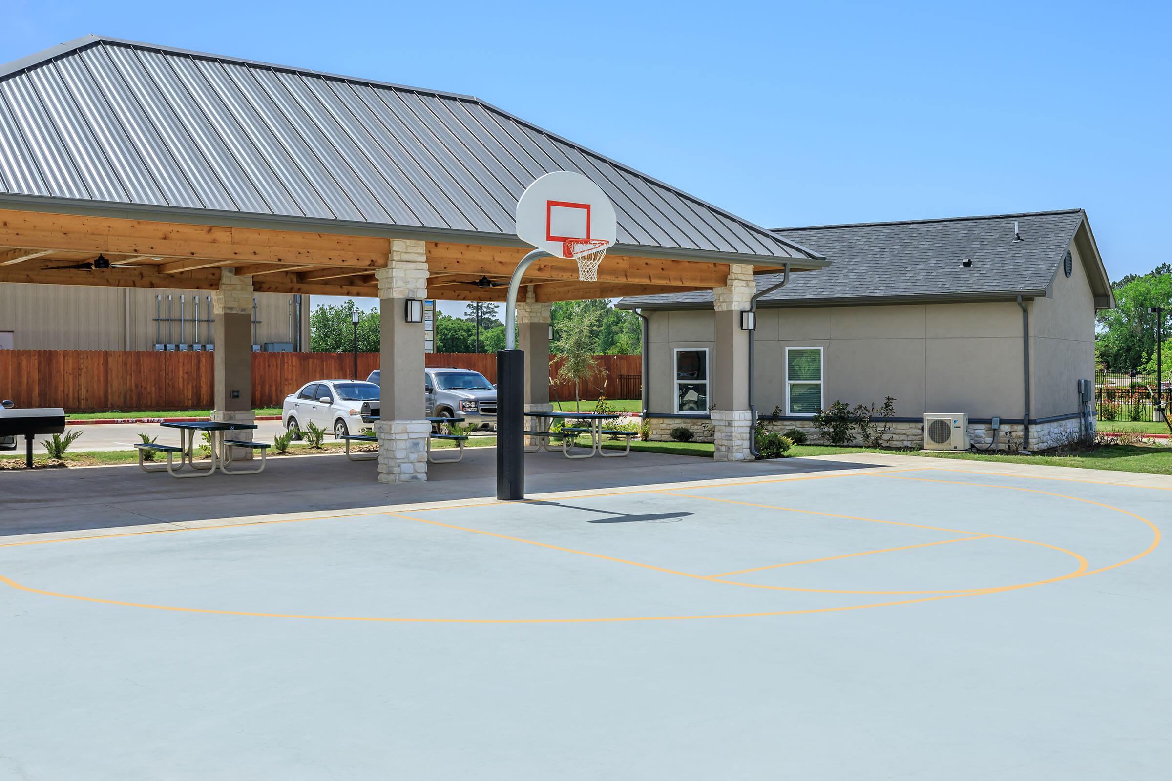 an empty parking lot in front of a house