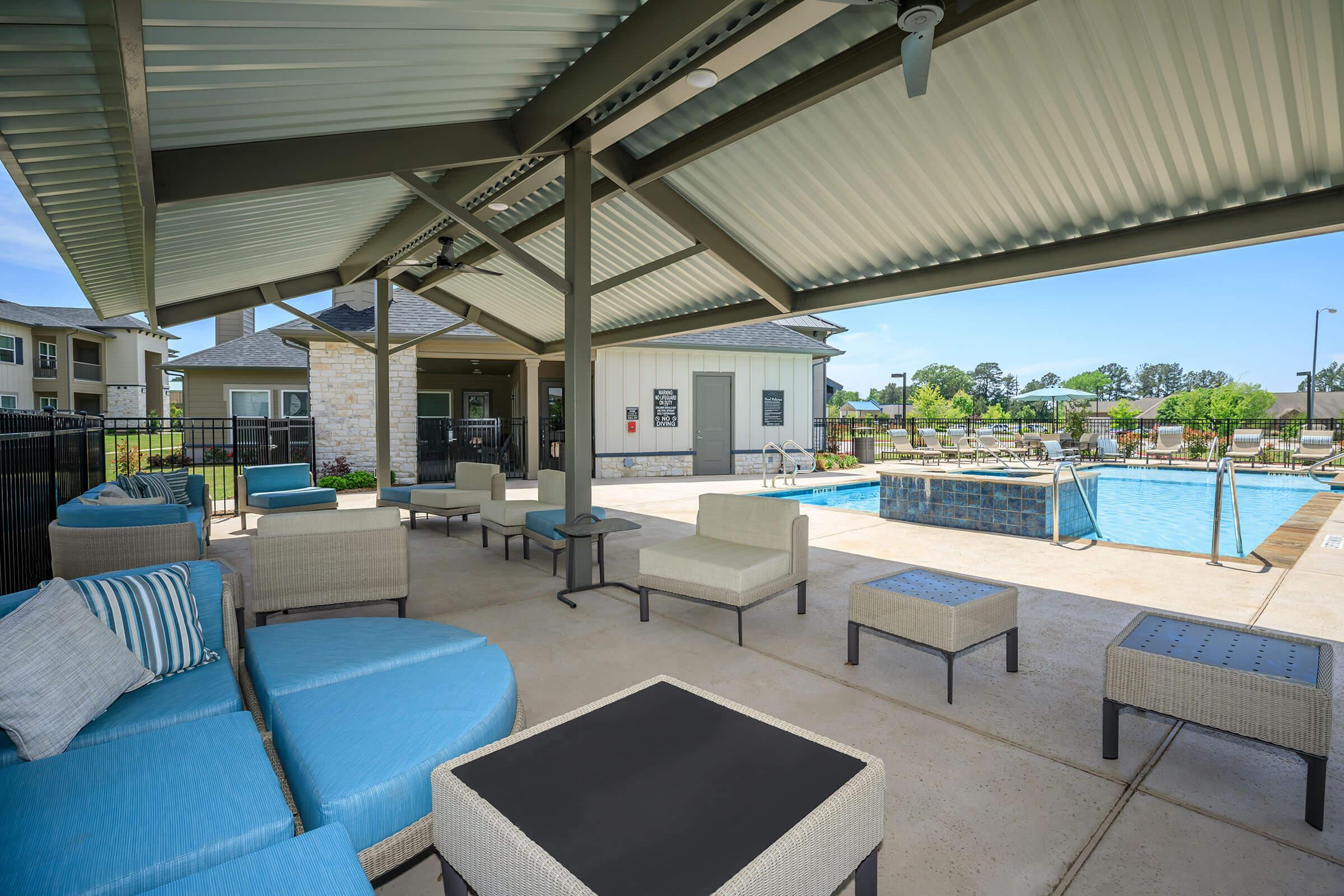 a room with a pool in front of a building