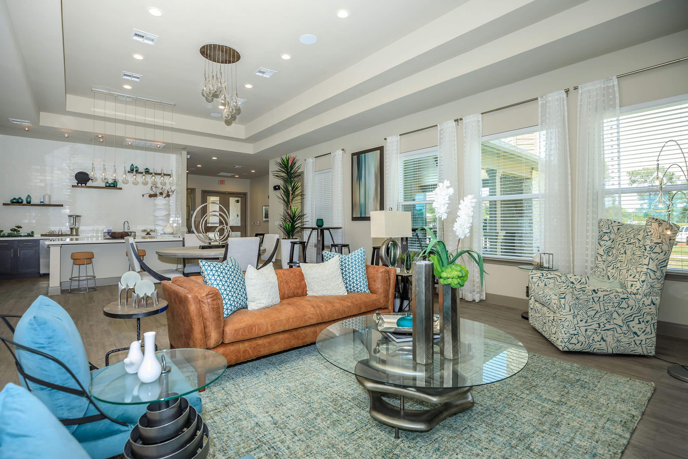 a living room filled with furniture and a large window