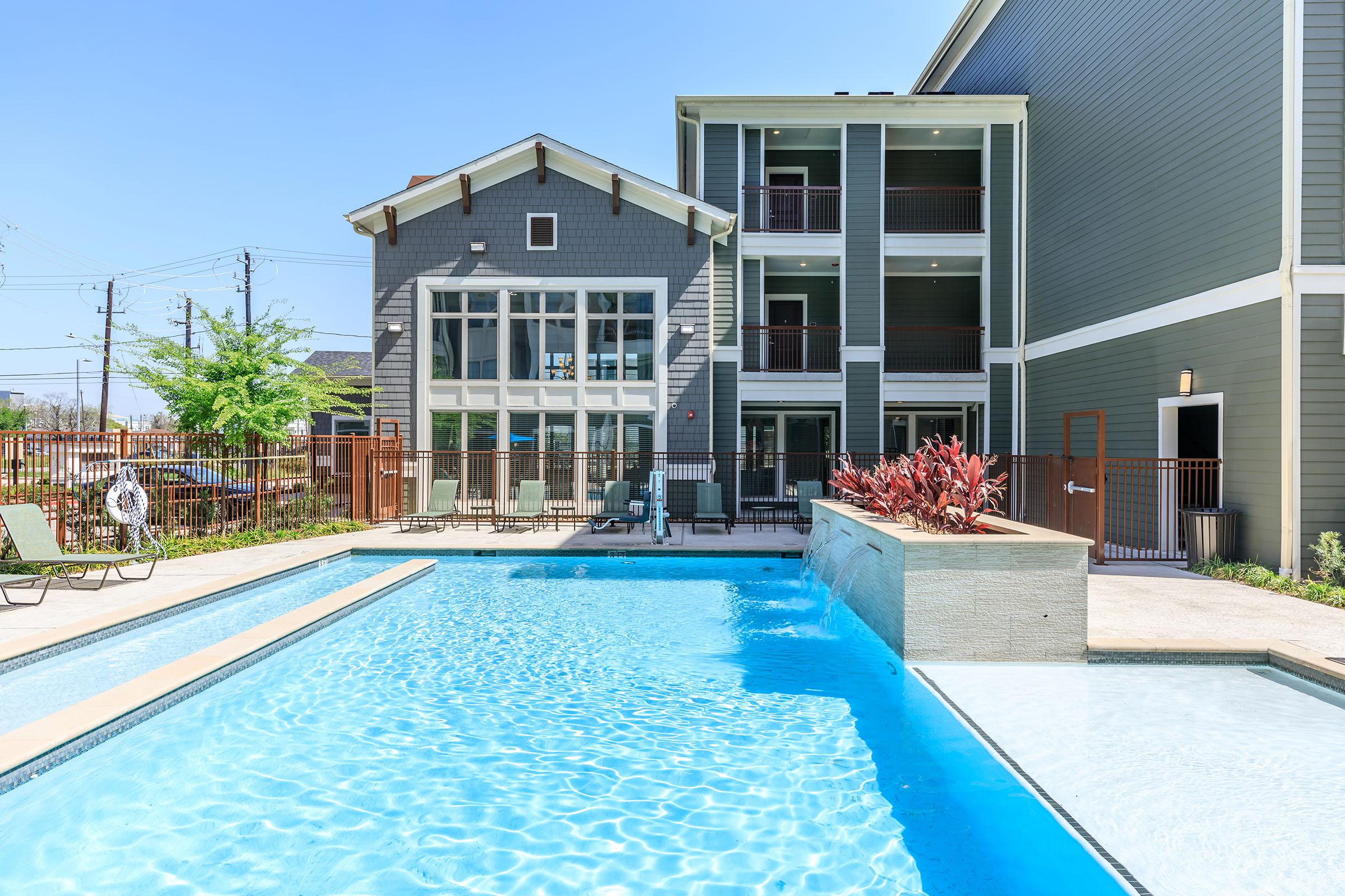 a house with a pool in front of a building