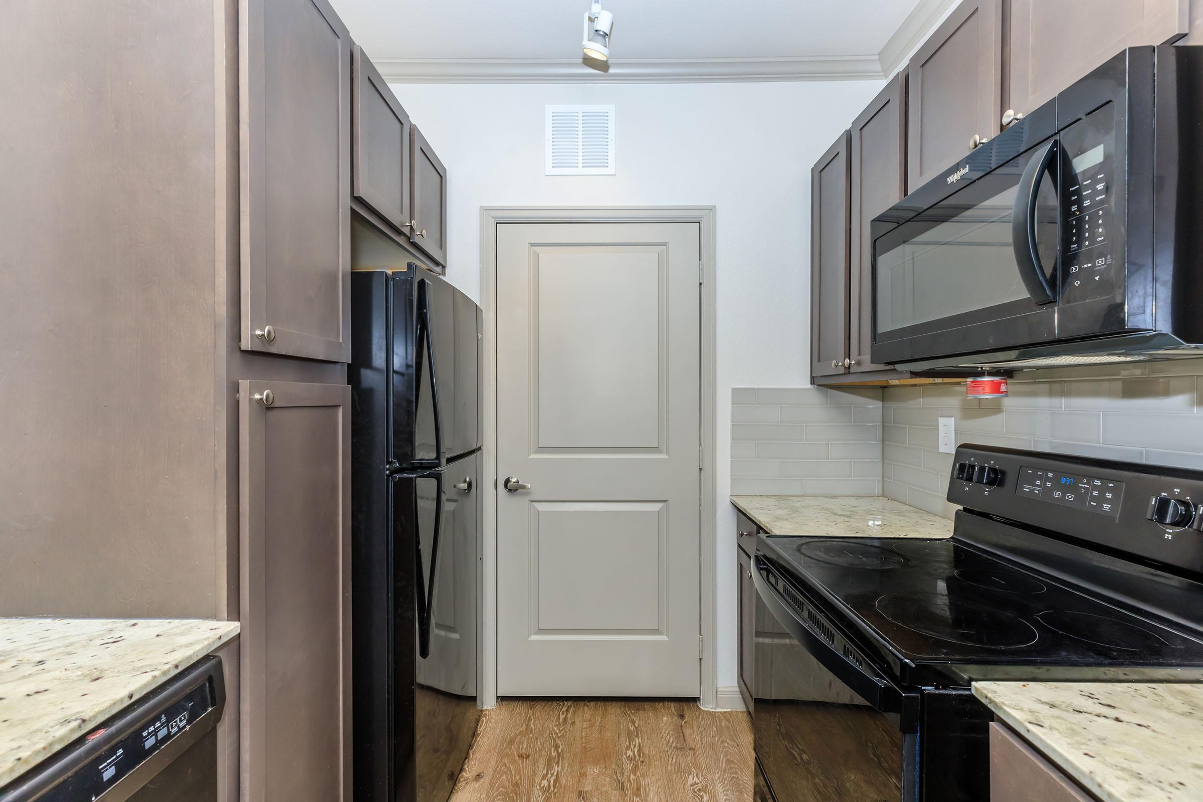 a kitchen with a stove top oven sitting inside of a building