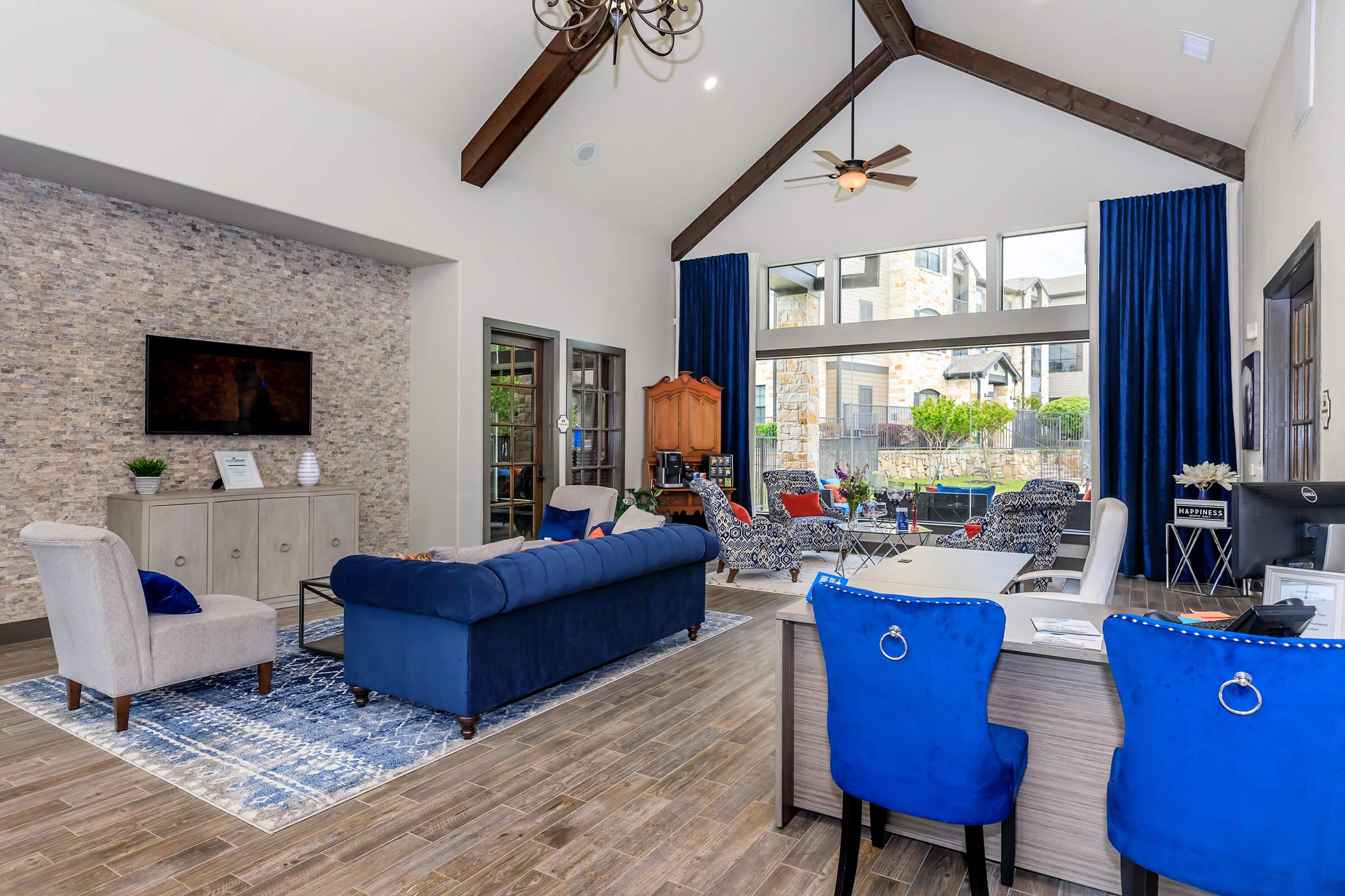 a living room filled with furniture and a large window