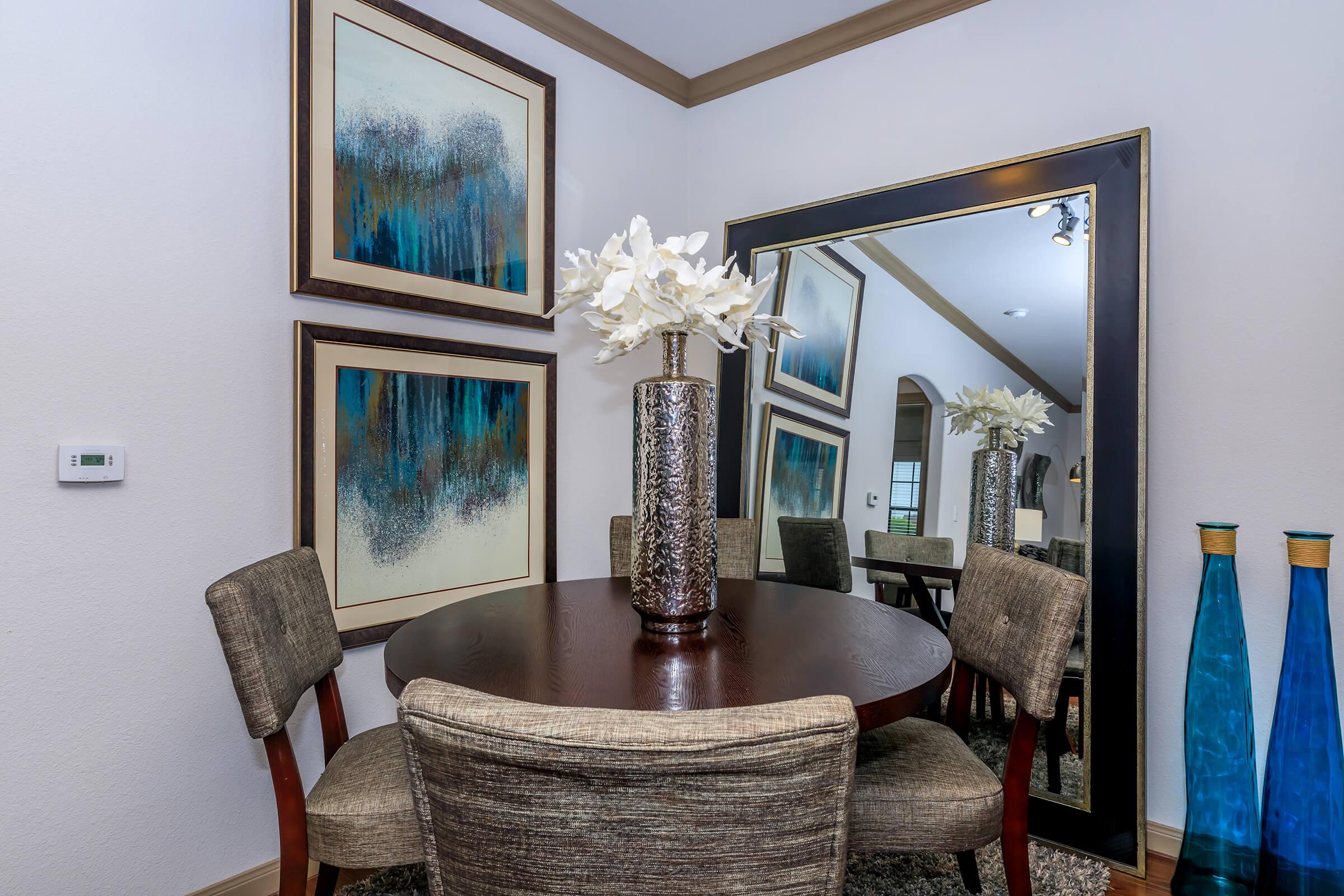 a room filled with furniture and vase of flowers on a table