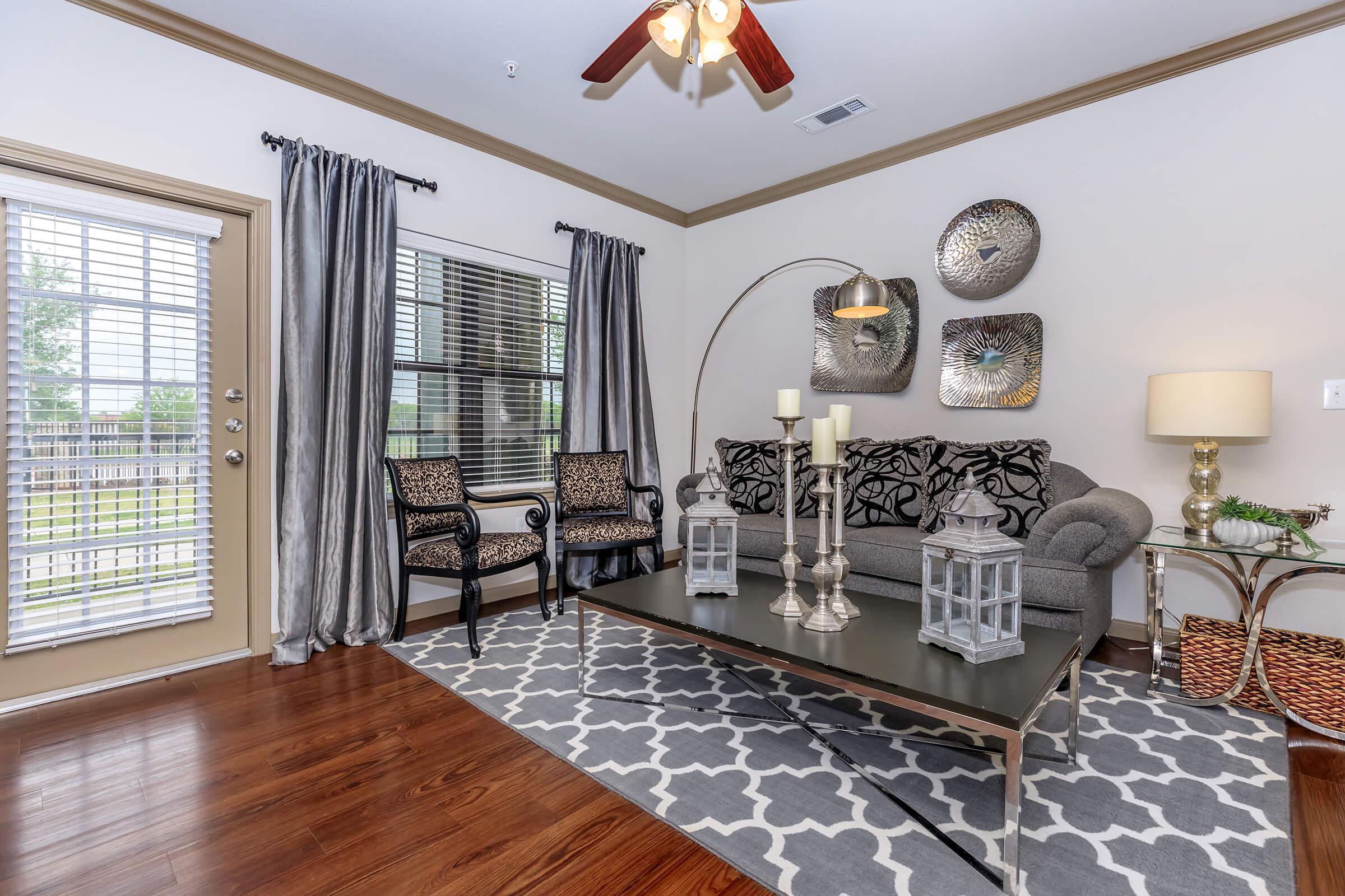 a living room filled with furniture and vase on a table