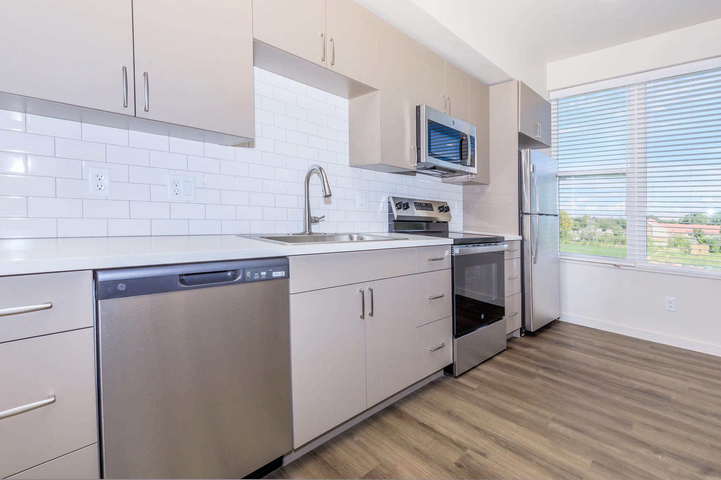 a kitchen with a stove and a refrigerator