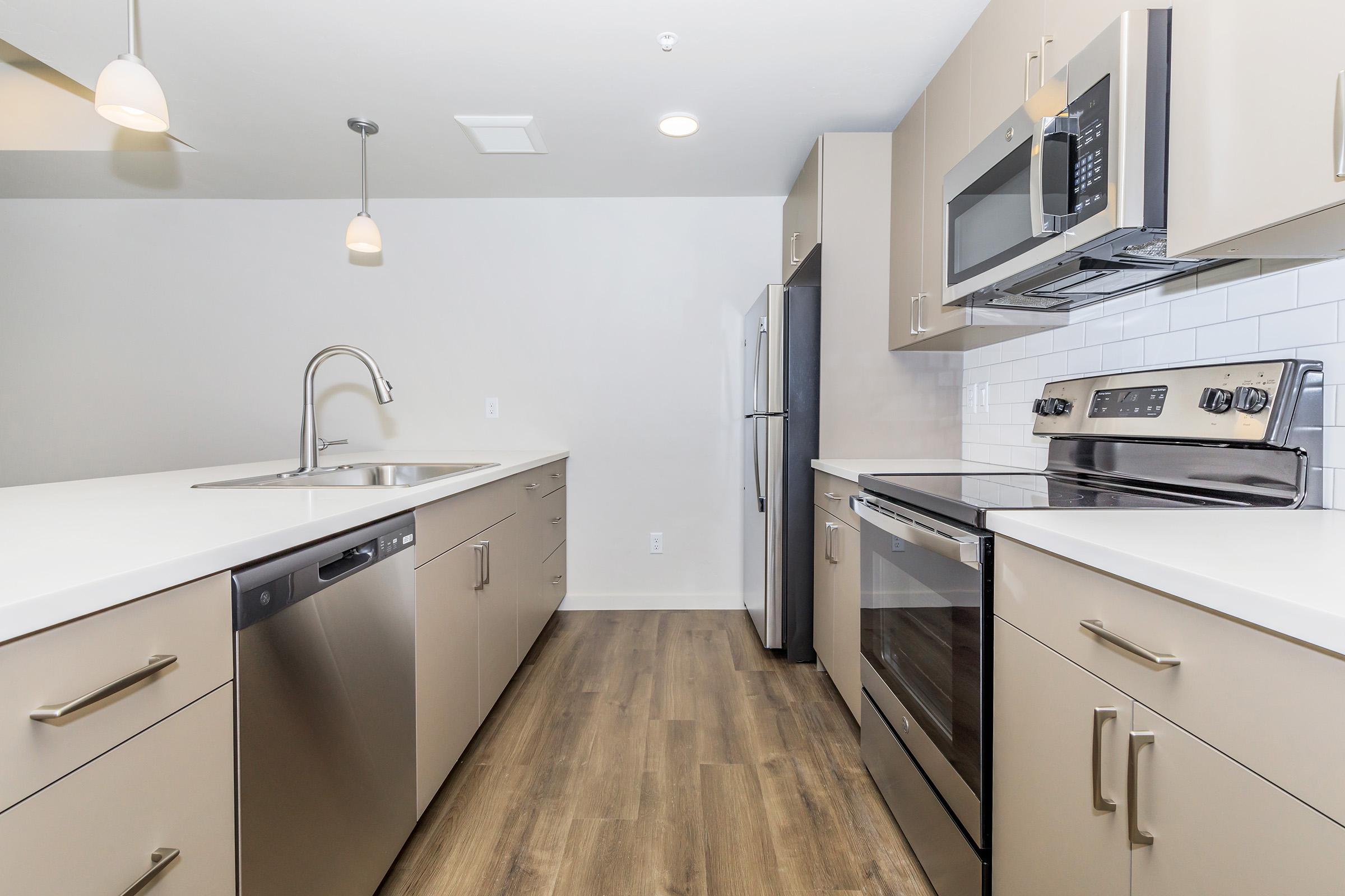 a kitchen with a sink and a refrigerator