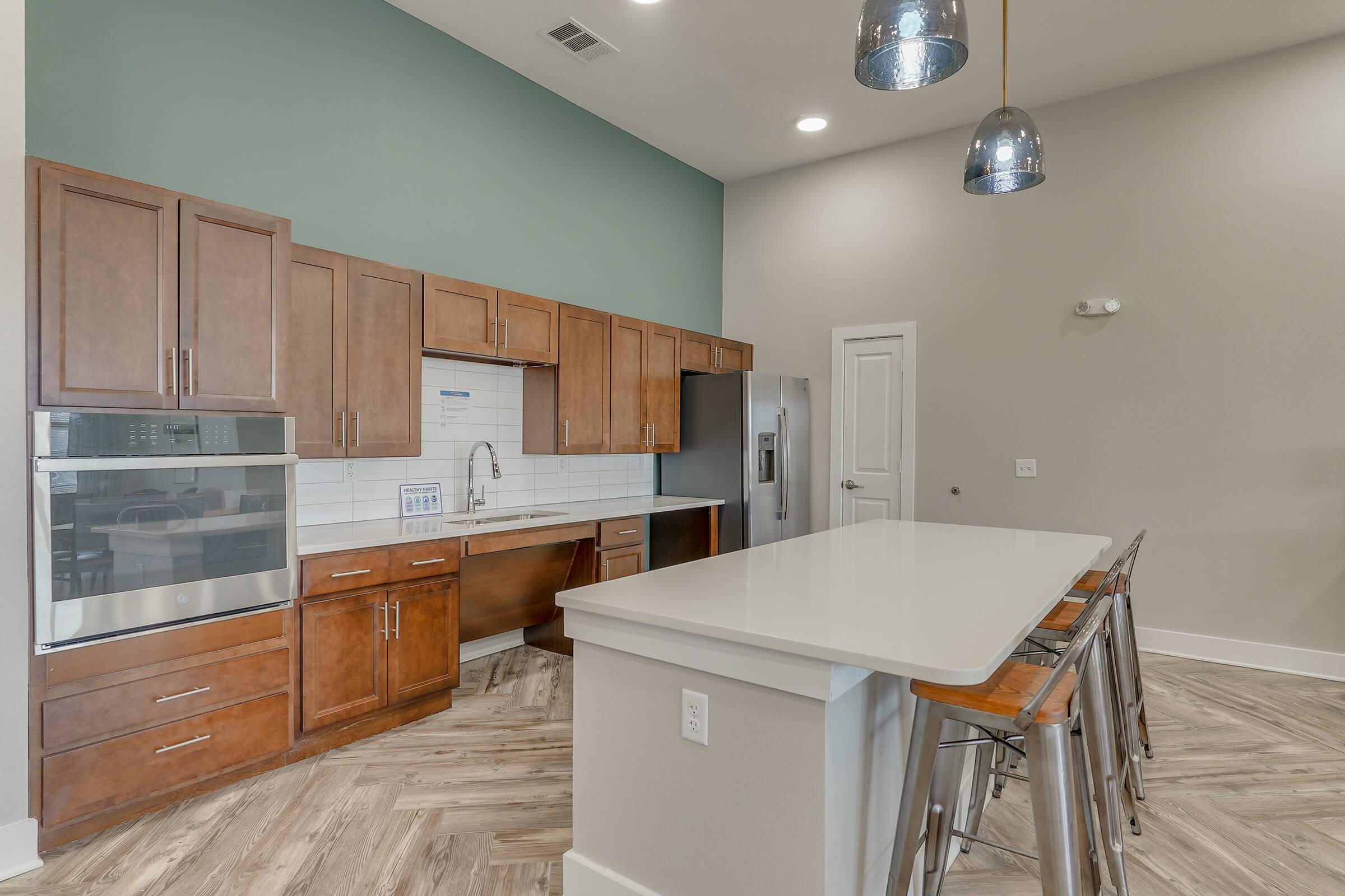 a kitchen with stainless steel appliances and wooden cabinets