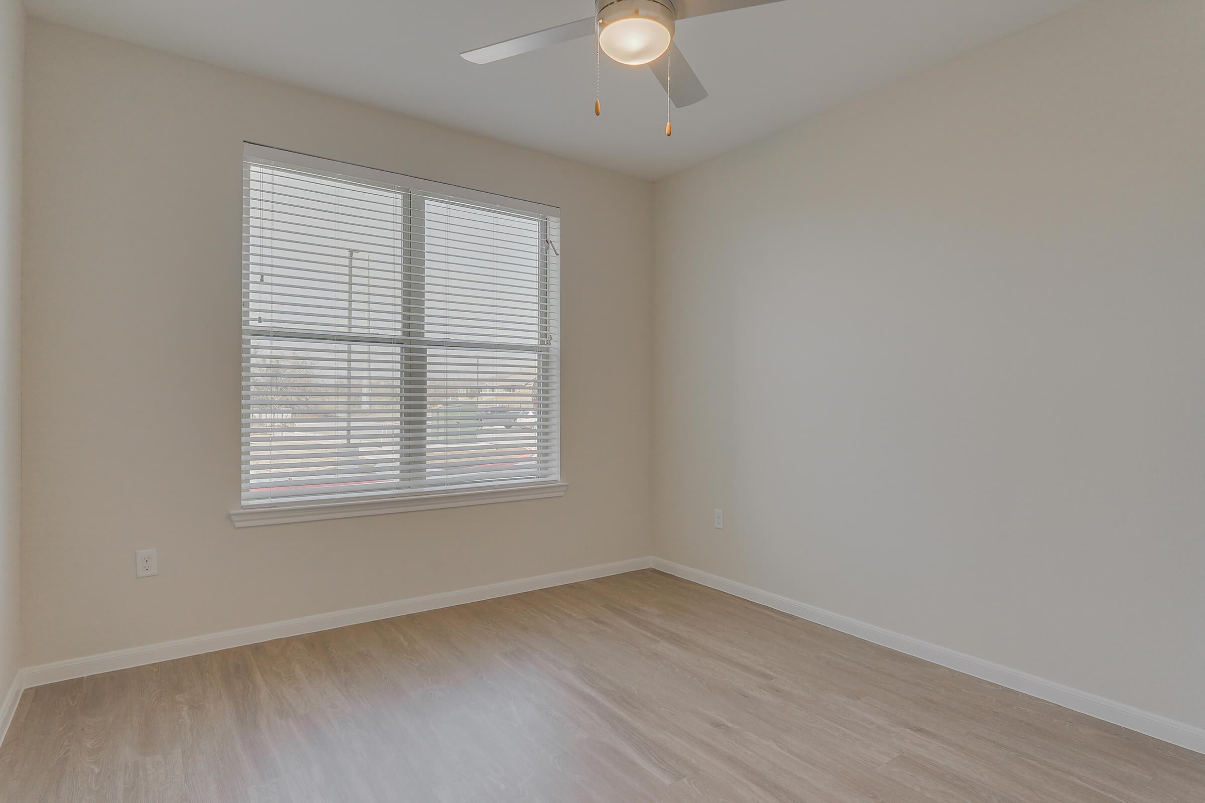 Apartments for Rent Pflugerville - Legacy Ranch at Dessau East Spacious Bedroom with a Expansive Closet, Wood-Style Flooring, and Many More Great Bedroom Amenities