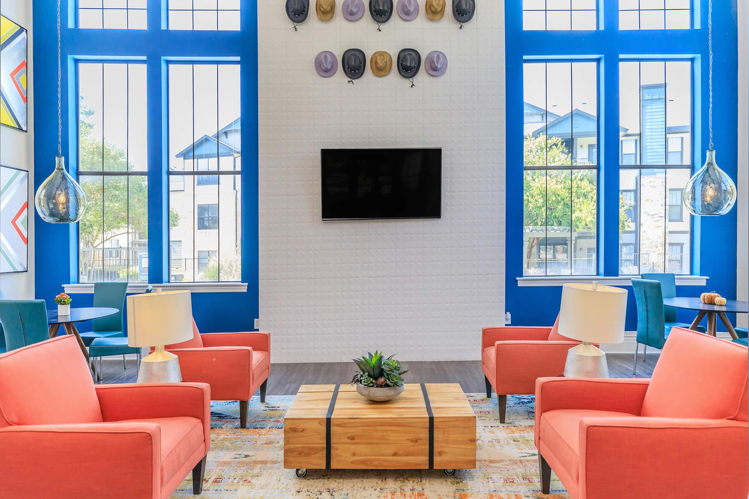 a living room filled with furniture and a large window