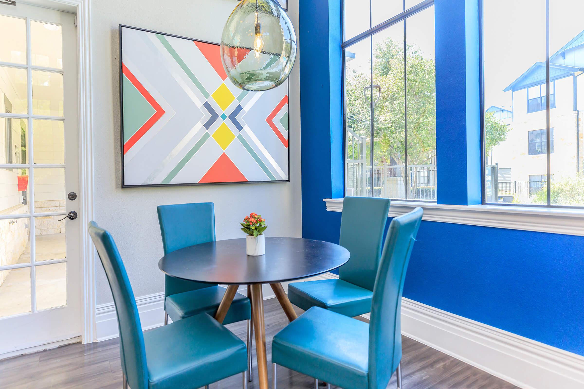 a dining room table with a blue chair