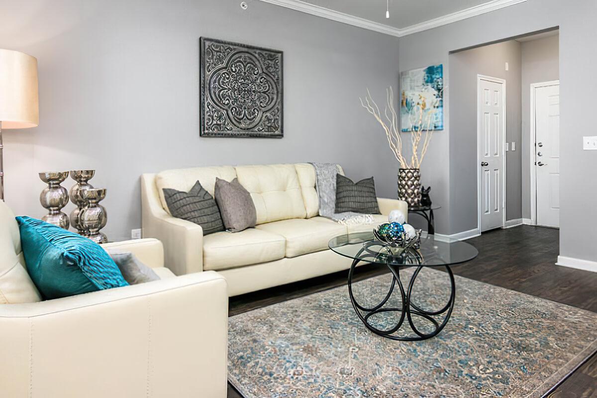 a living room filled with furniture and a flat screen tv