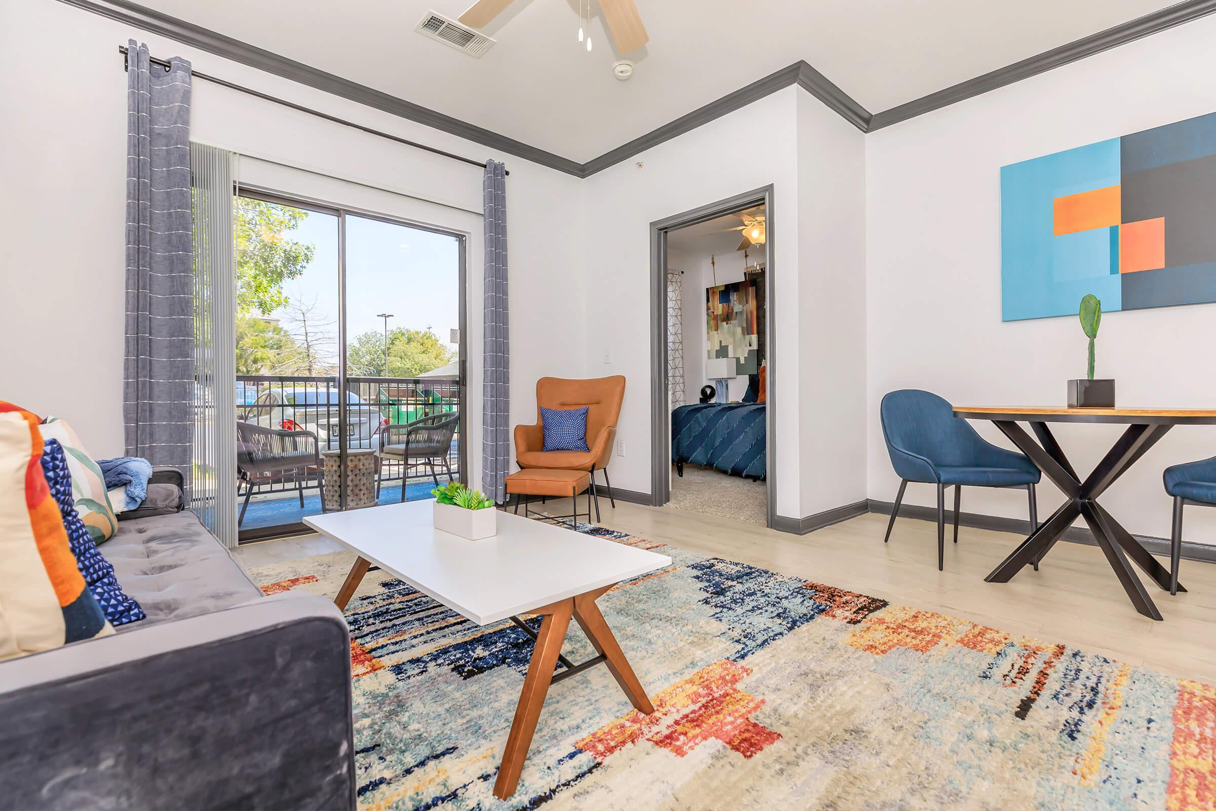 a living room filled with furniture and a large window