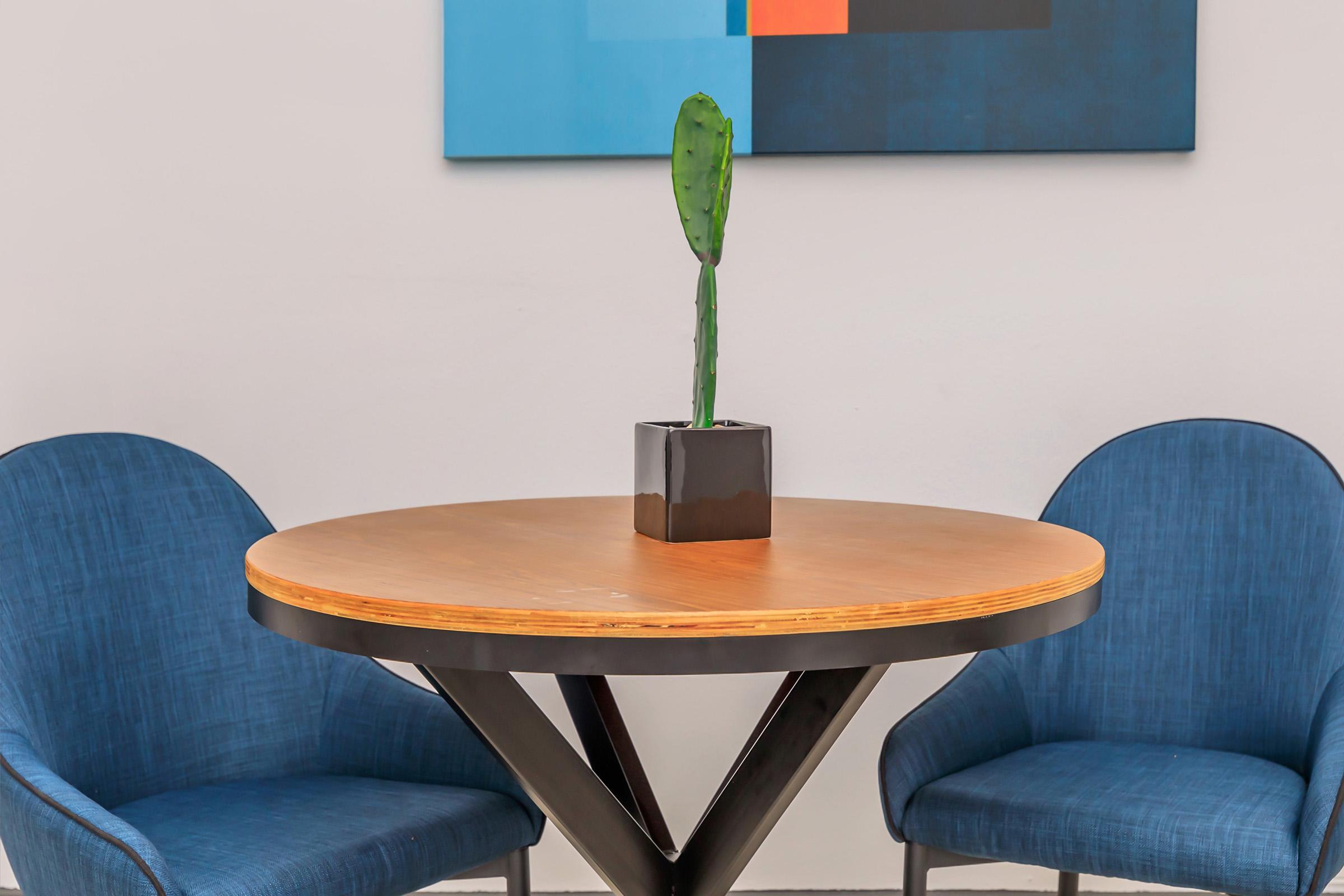 a table topped with a blue chair