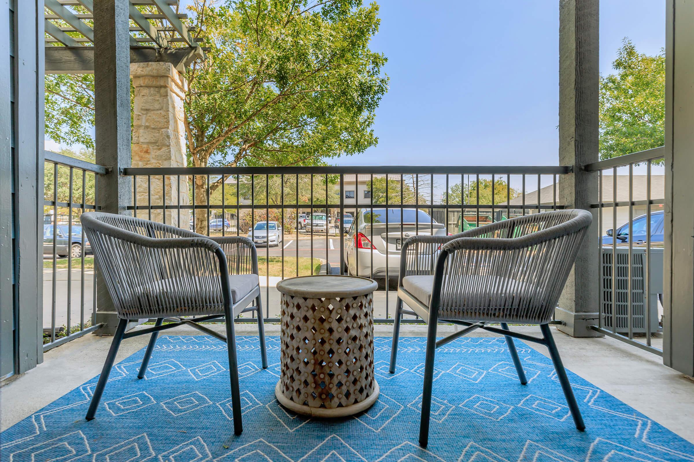 a chair sitting in front of a fence