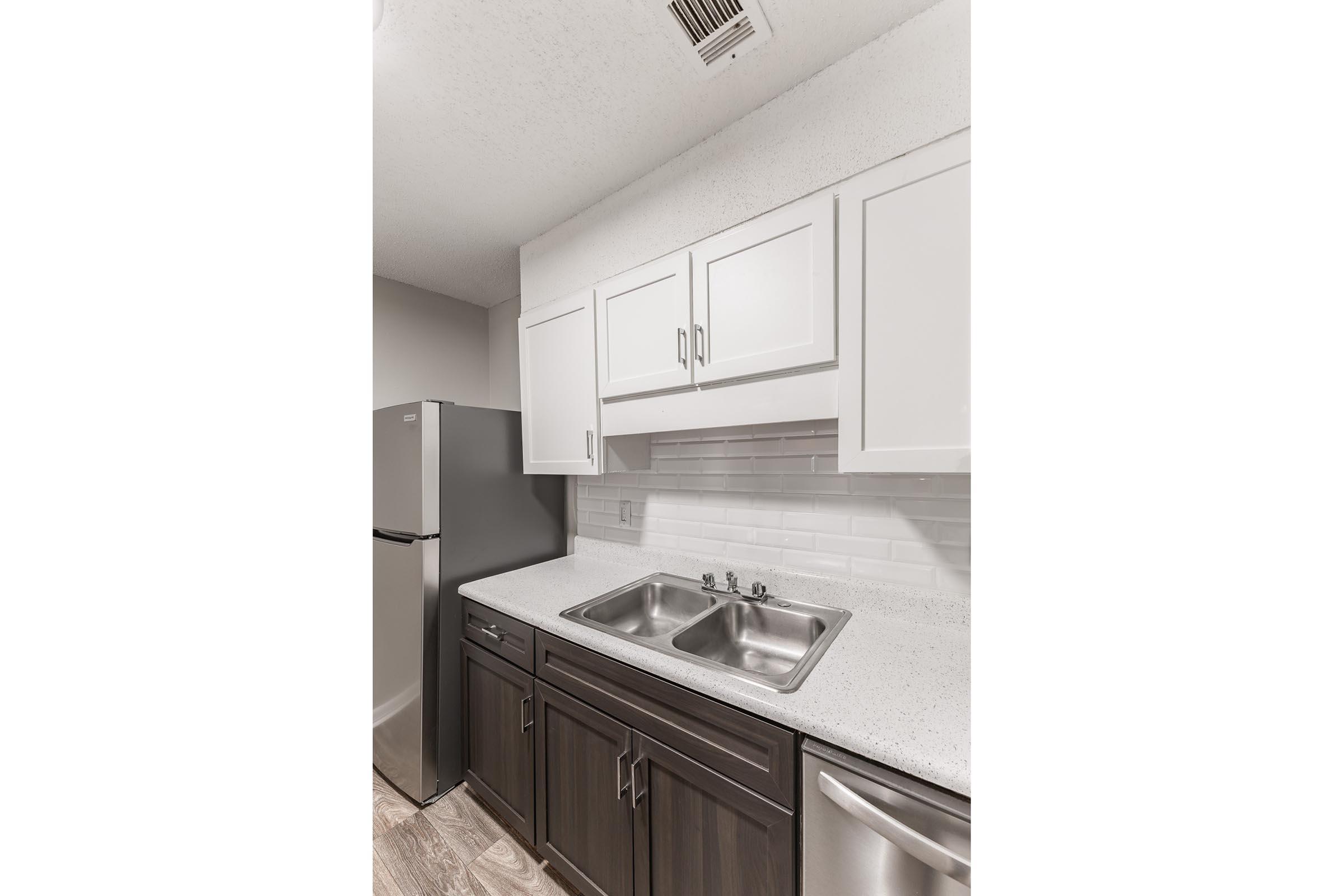 a kitchen with a sink and a refrigerator