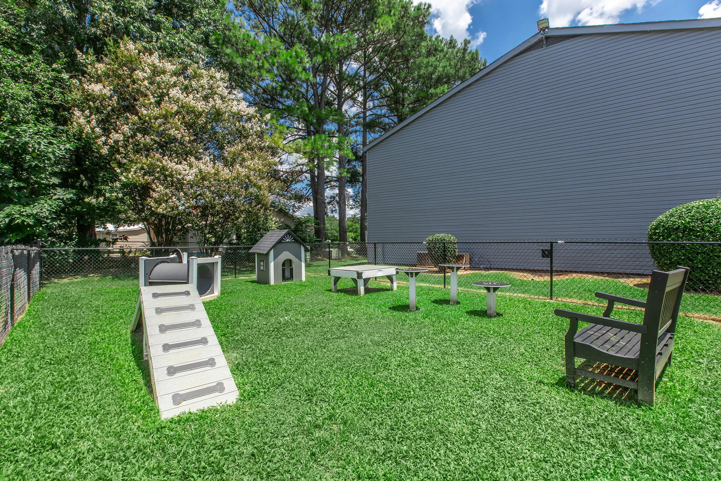 a couple of lawn chairs sitting on top of a grass covered field