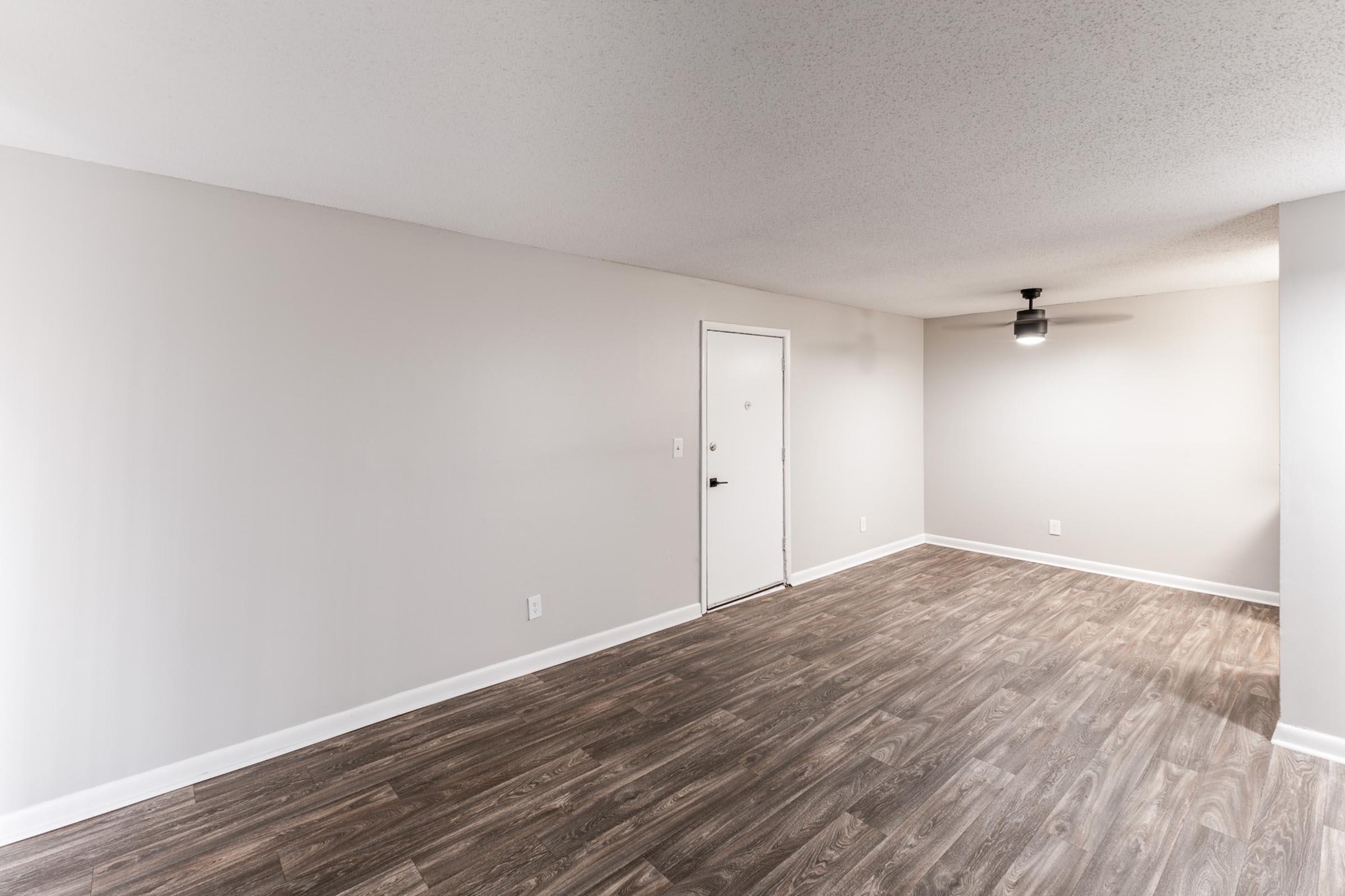 a bedroom with a wooden floor