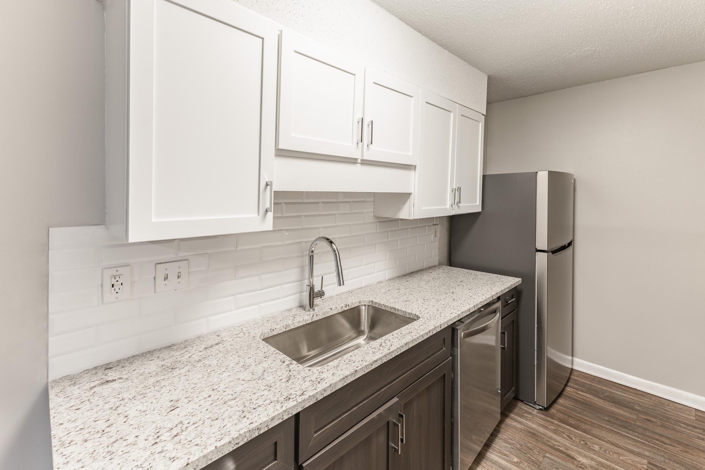 a kitchen with a sink and a mirror