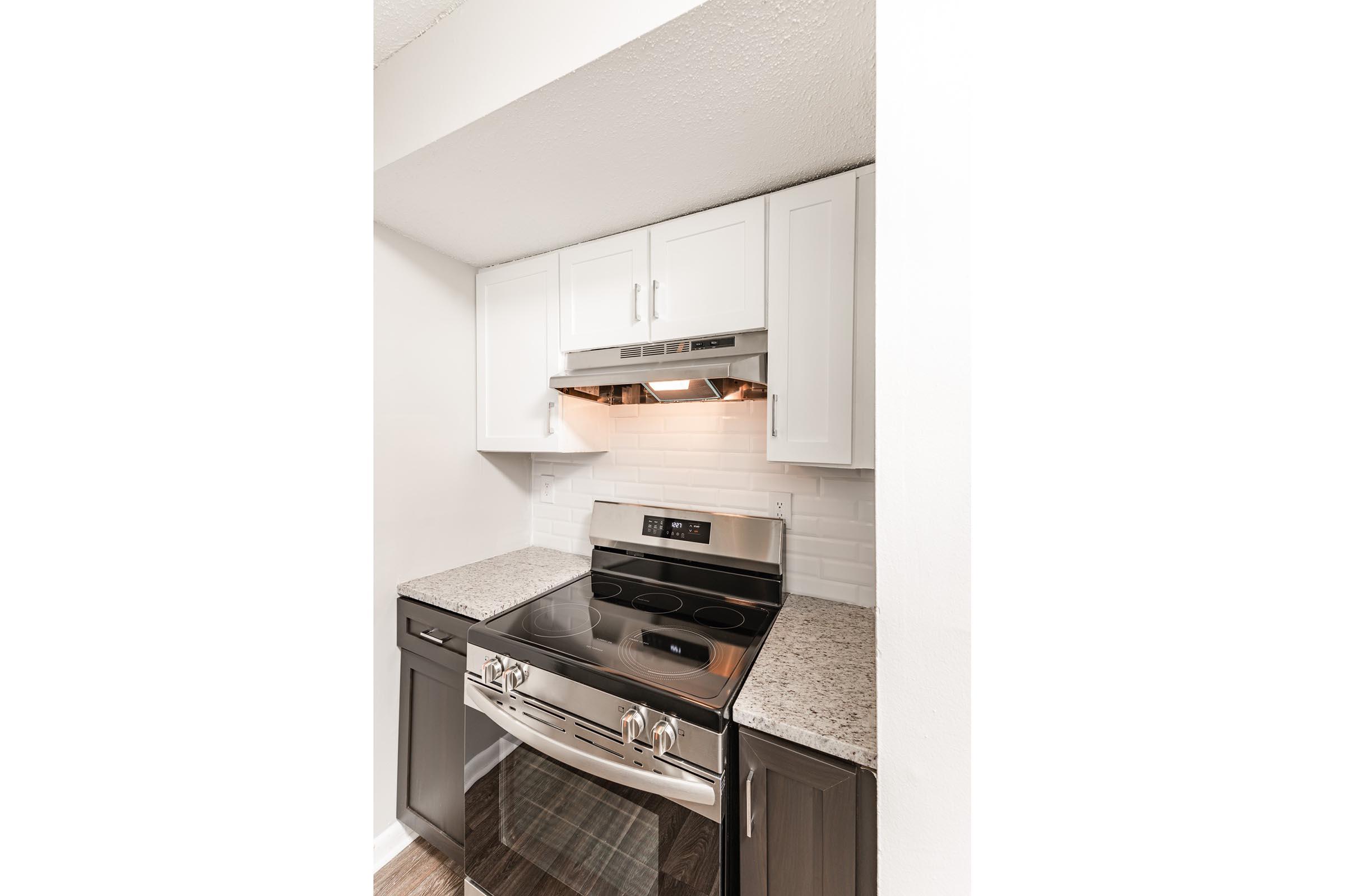 a stove top oven sitting inside of a kitchen