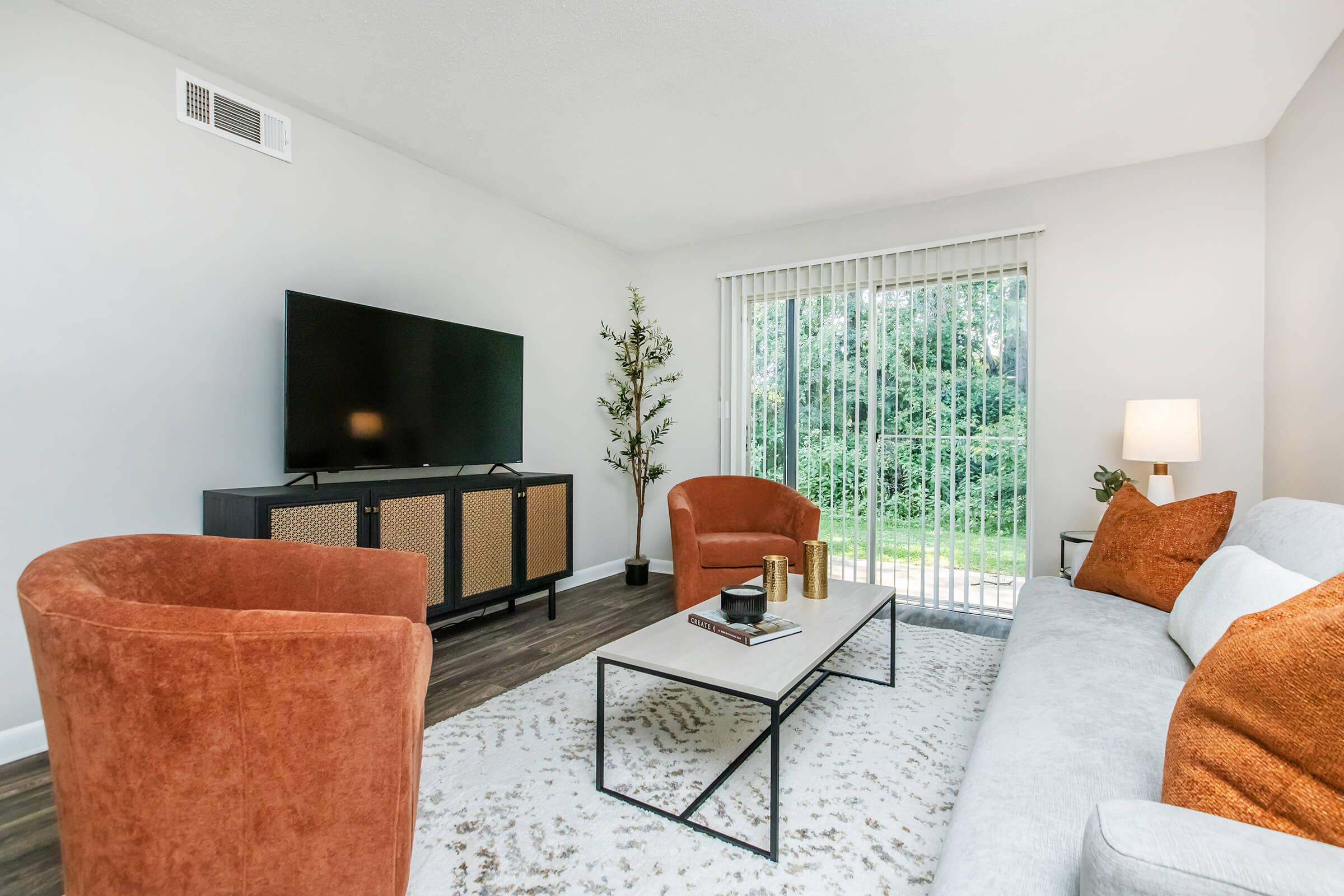 a living room filled with furniture and a flat screen tv