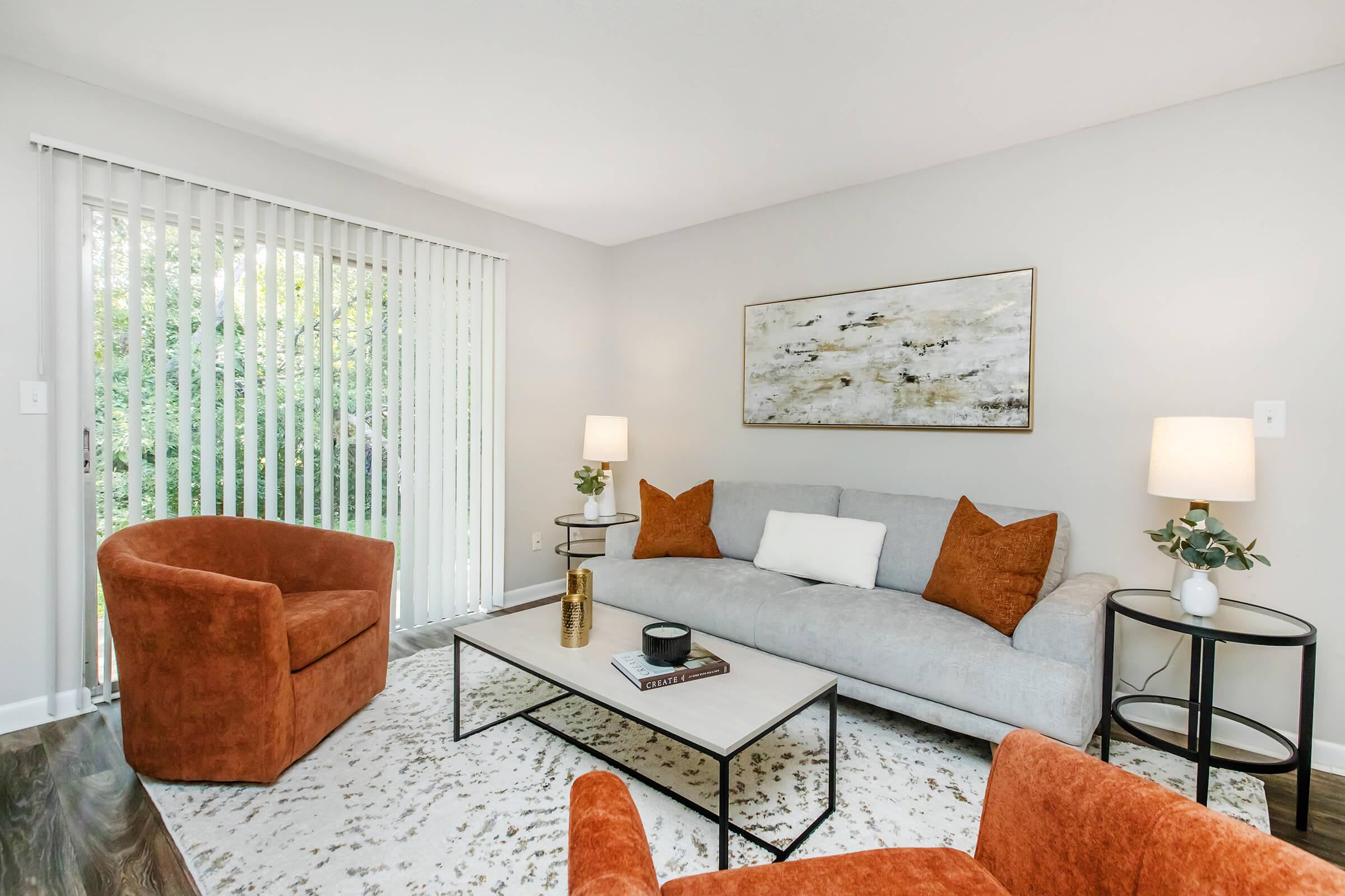 a living room filled with furniture and a flat screen tv