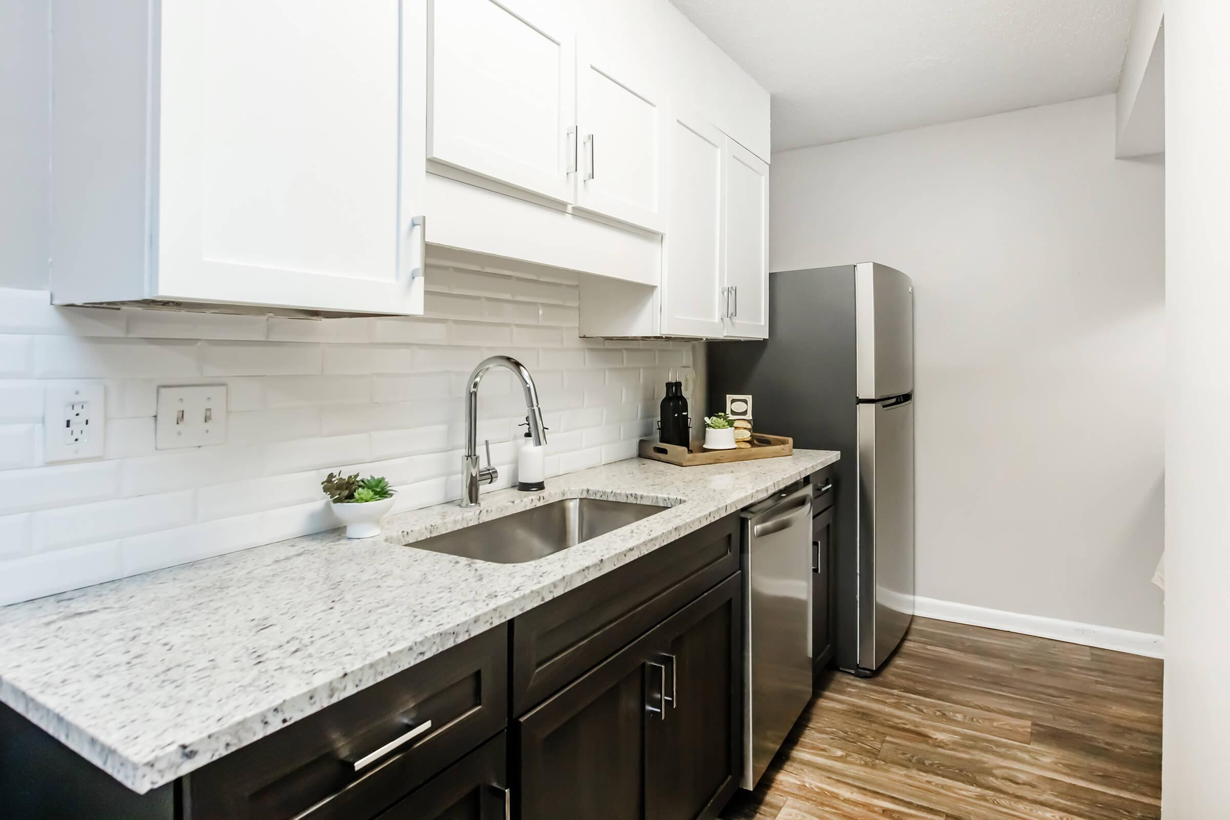 a kitchen with a sink and a mirror