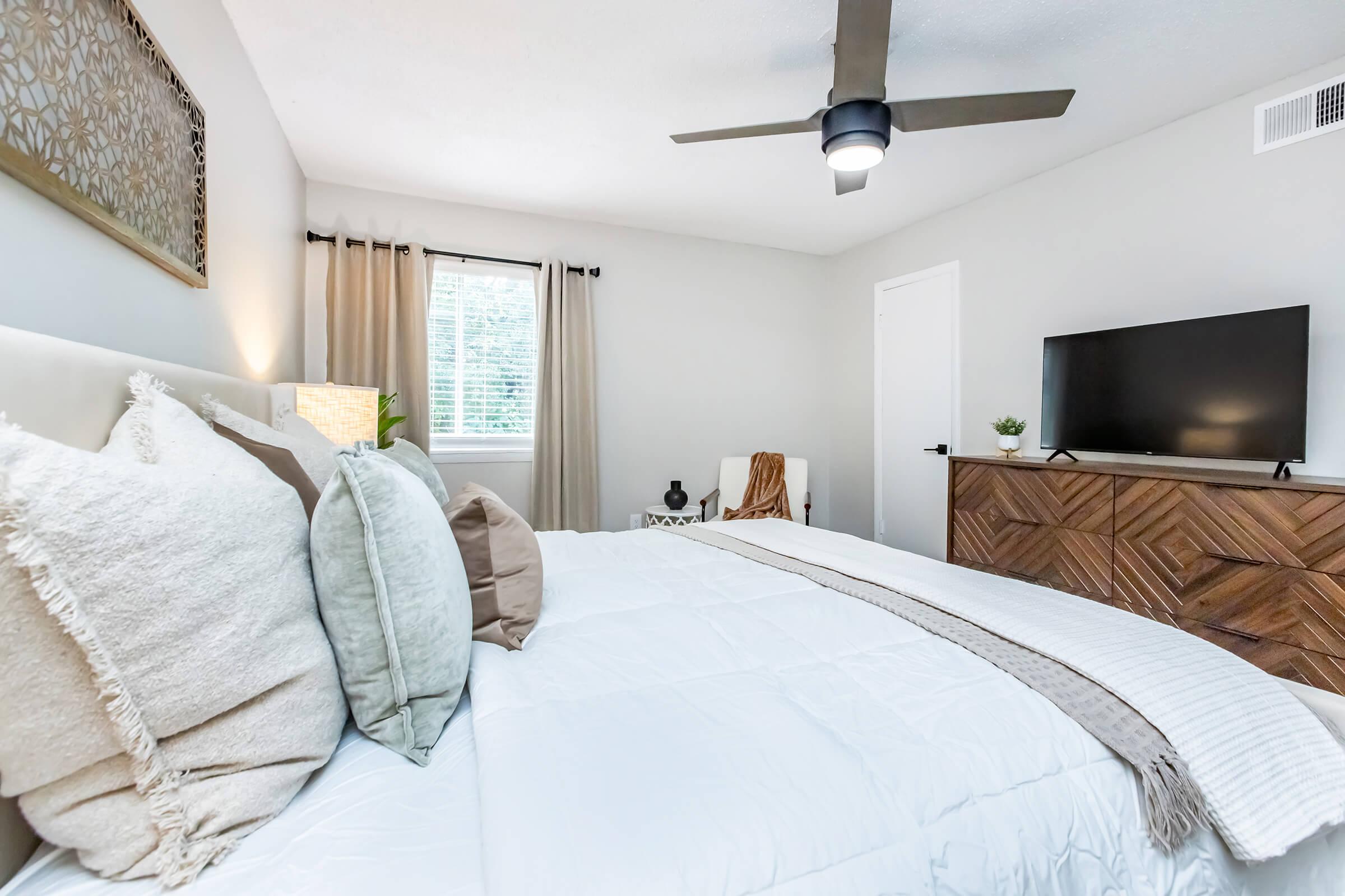 a bedroom with a large bed in a hotel room