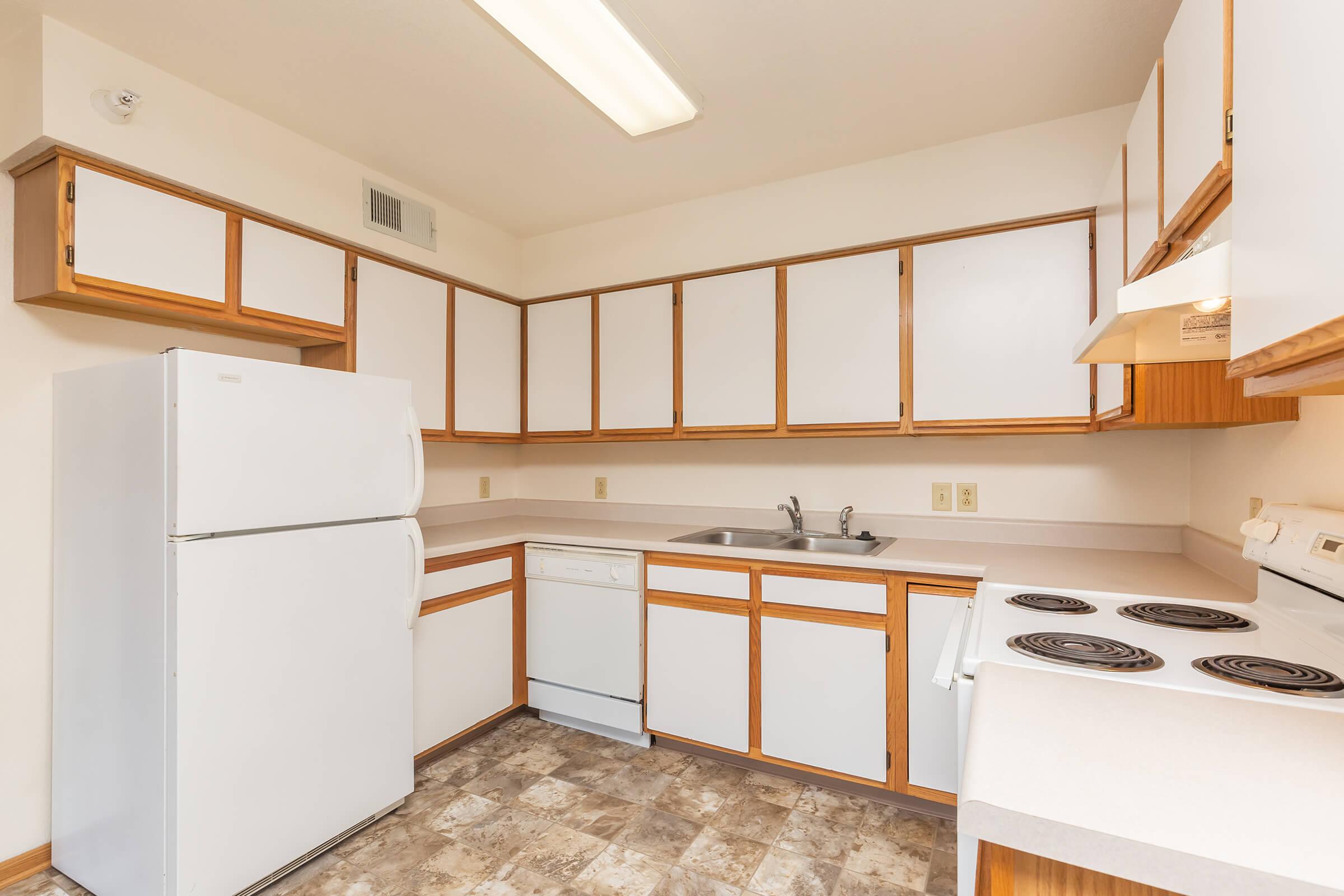 a kitchen with a stove and a refrigerator