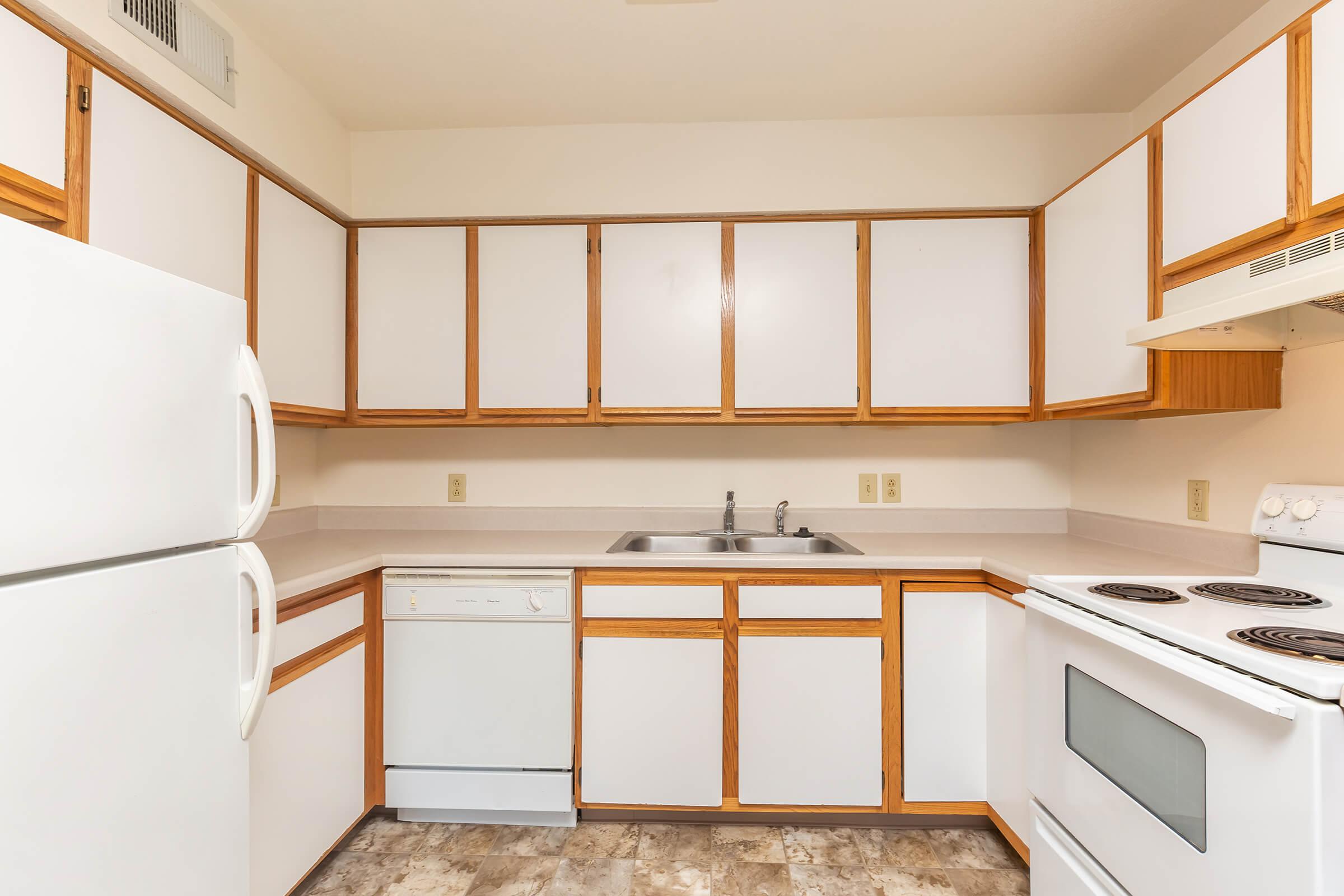 a kitchen with a stove top oven sitting next to a window