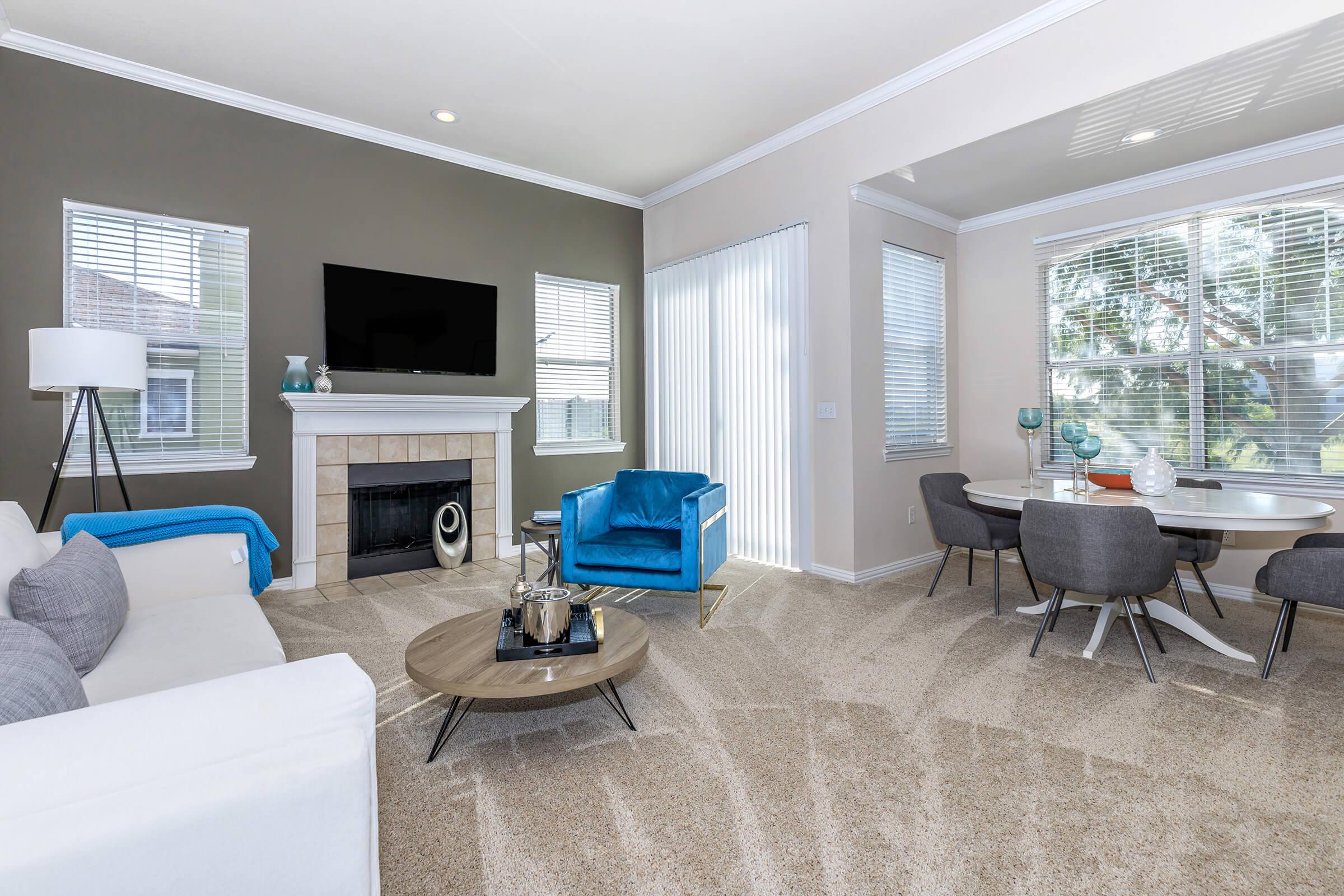 carpeted living room with a fireplace