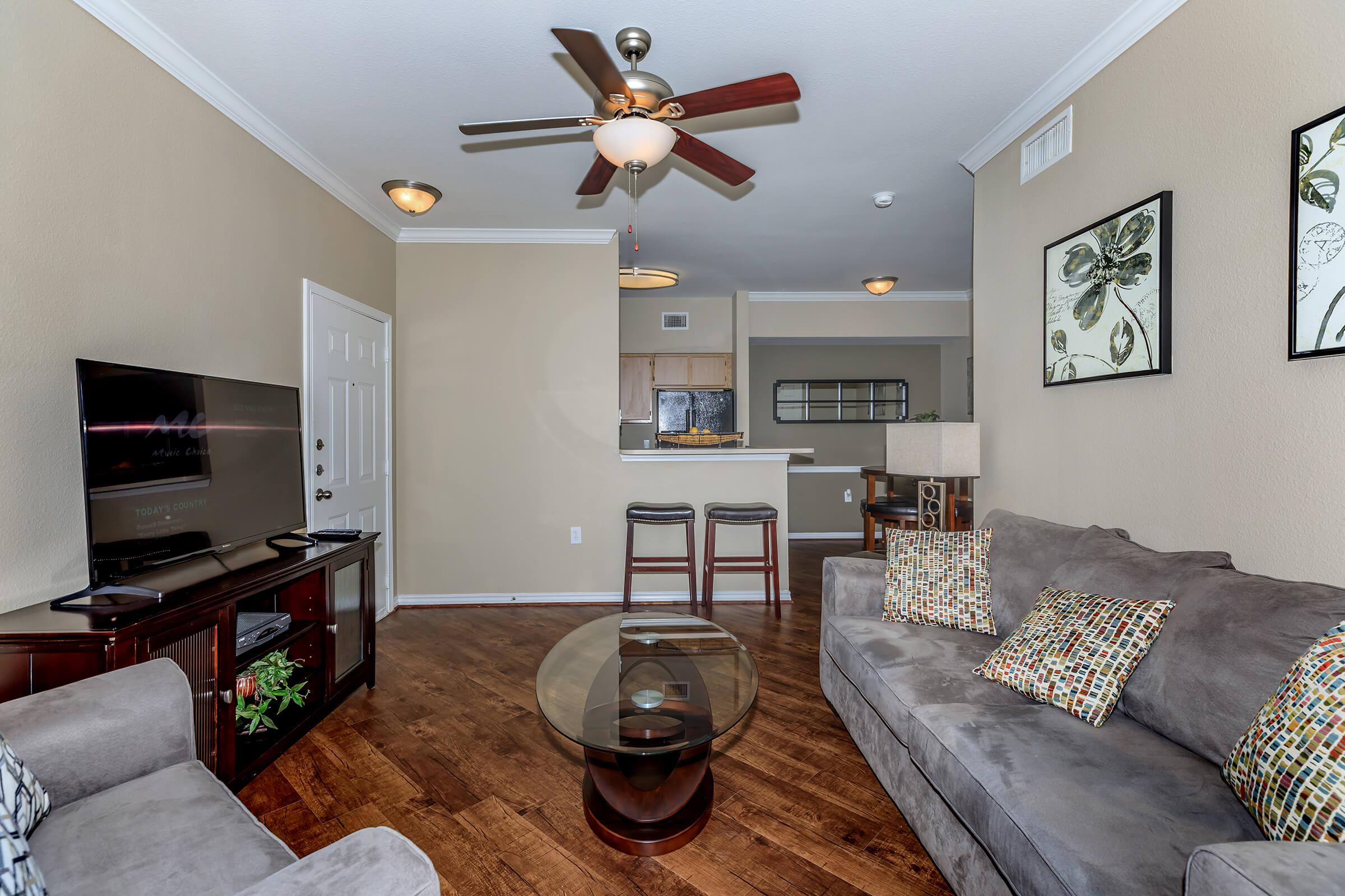 a living room filled with furniture and a flat screen tv