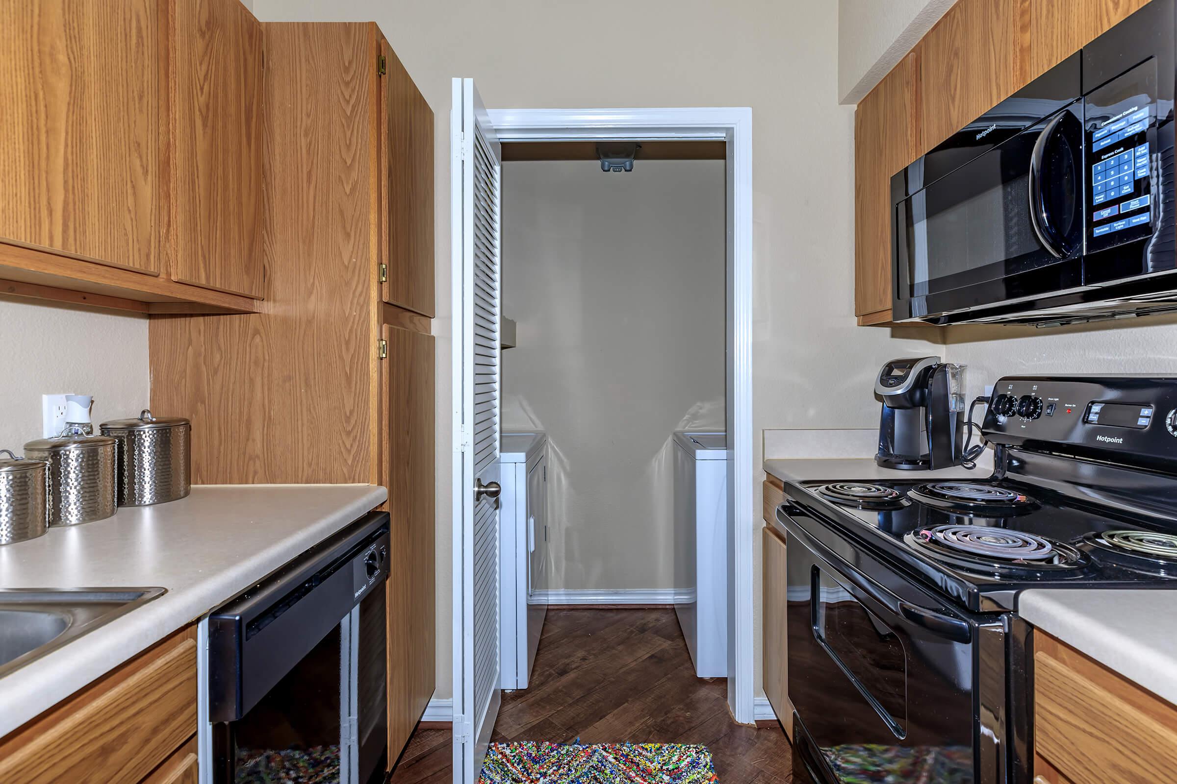 a kitchen with a stove a sink and a microwave