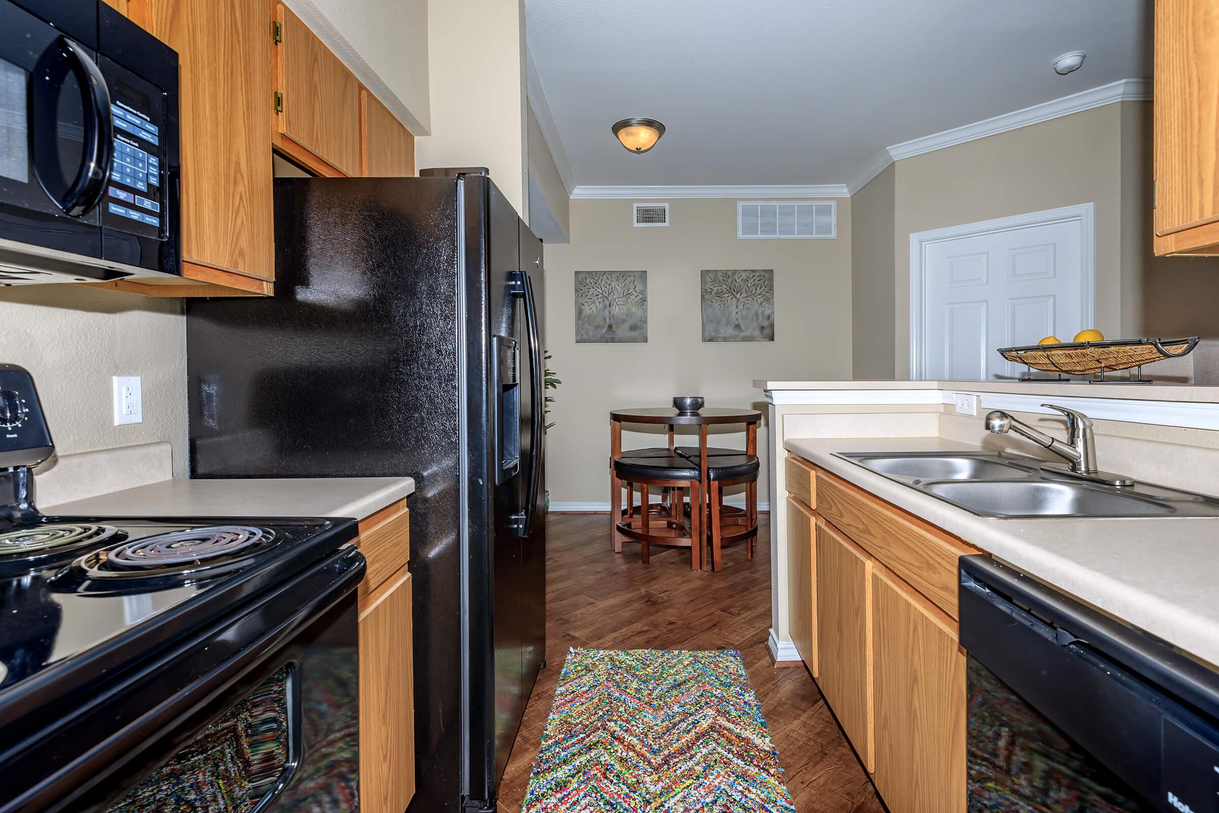 a modern kitchen with stainless steel appliances and wooden cabinets