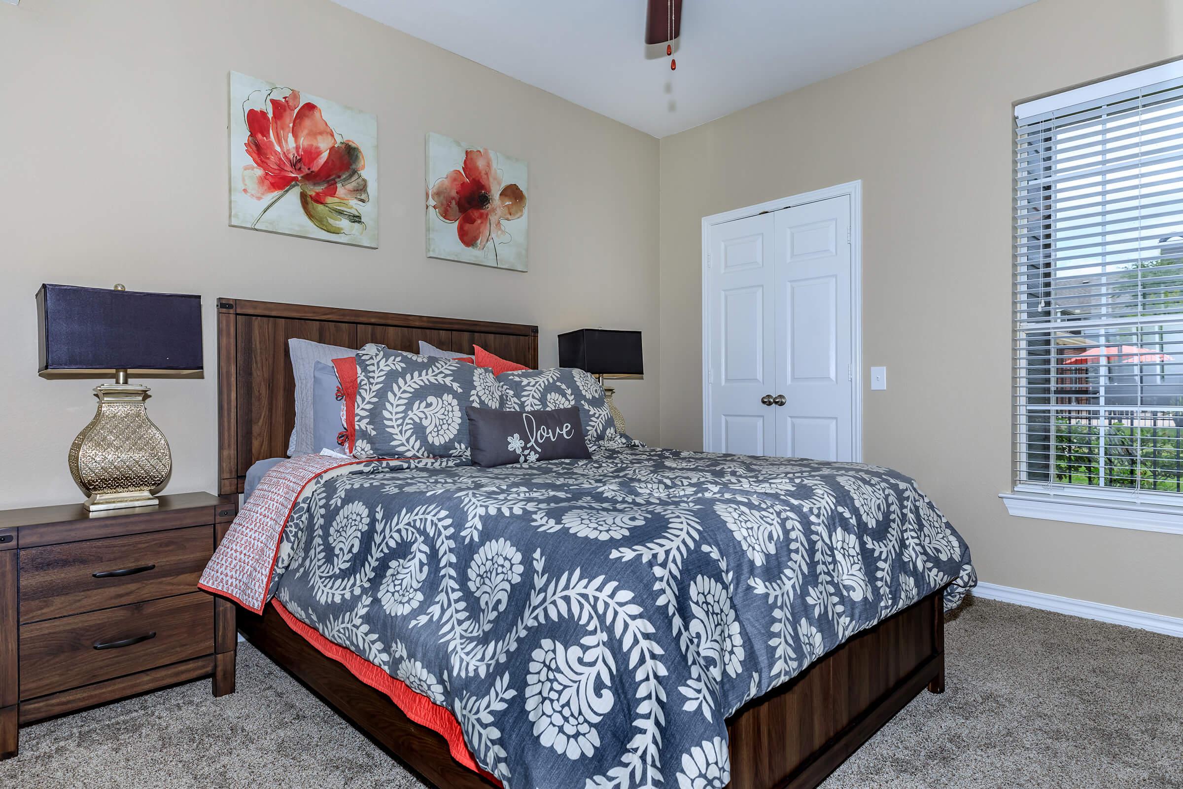 a bedroom with a bed and desk in a room