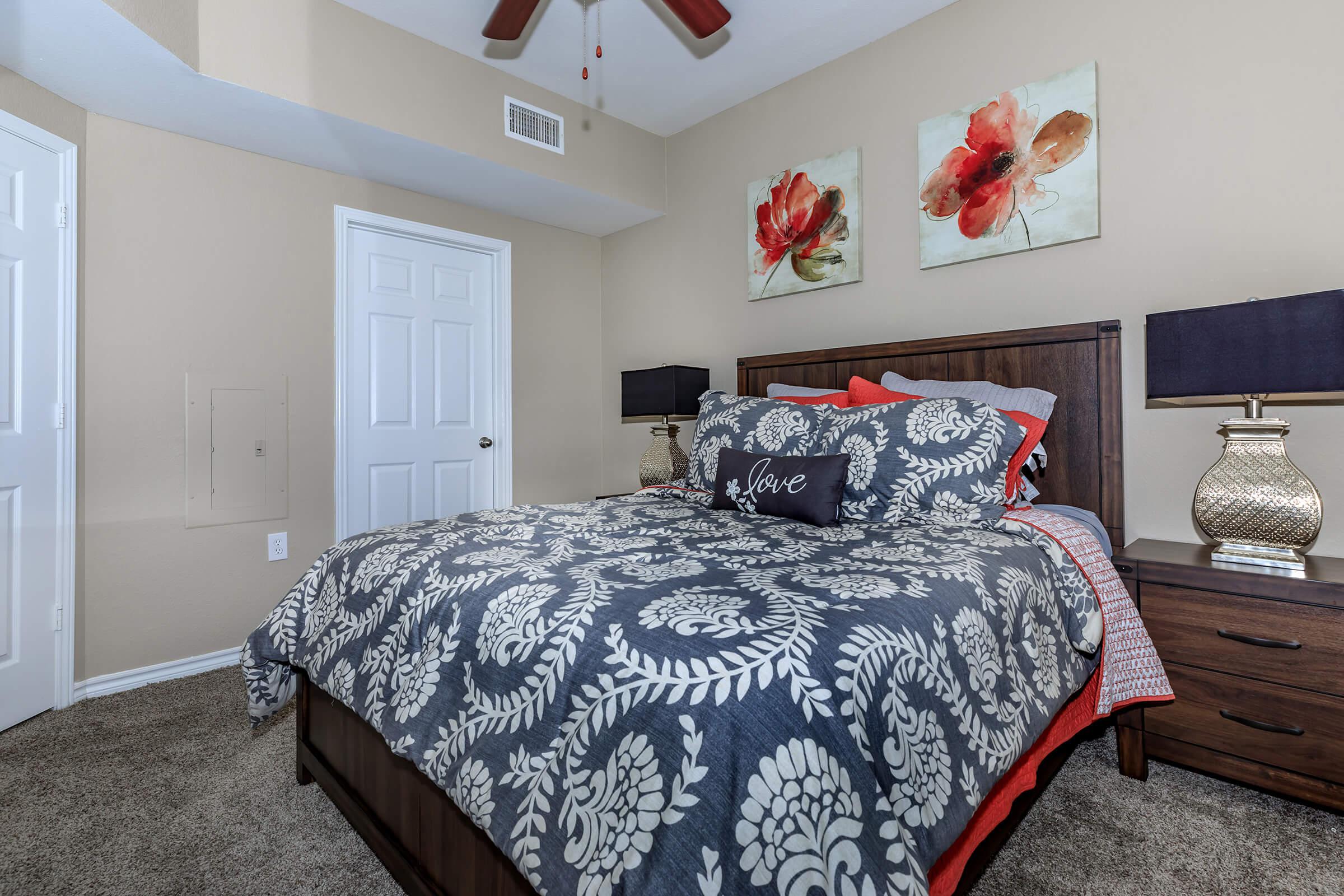 a bedroom with a bed and desk in a room