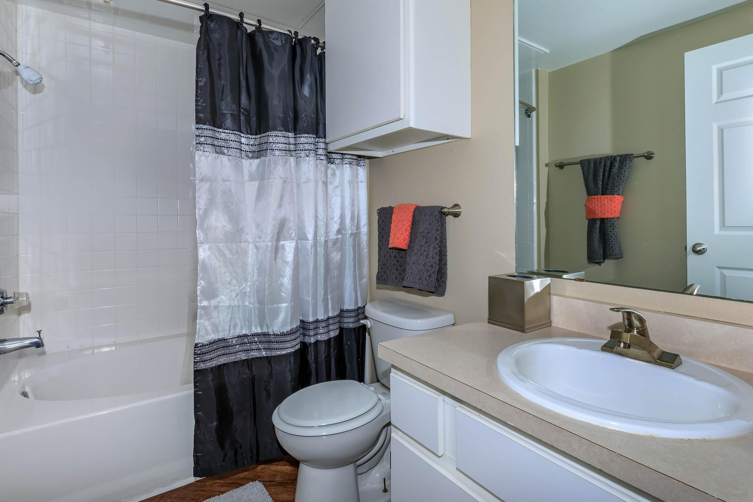 a large white tub next to a sink