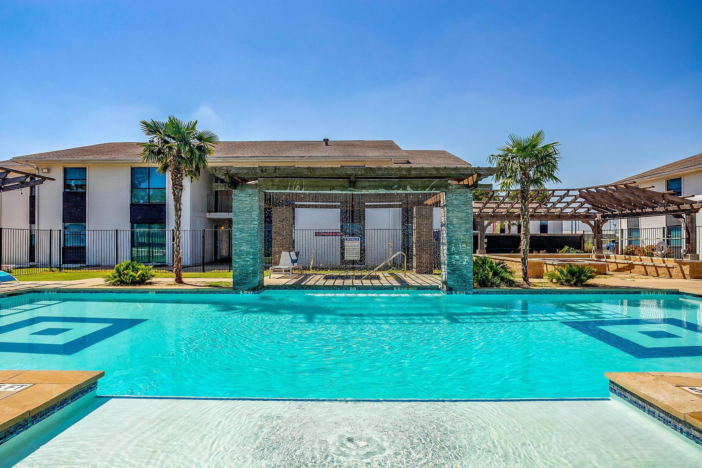 a blue pool of water in front of a building