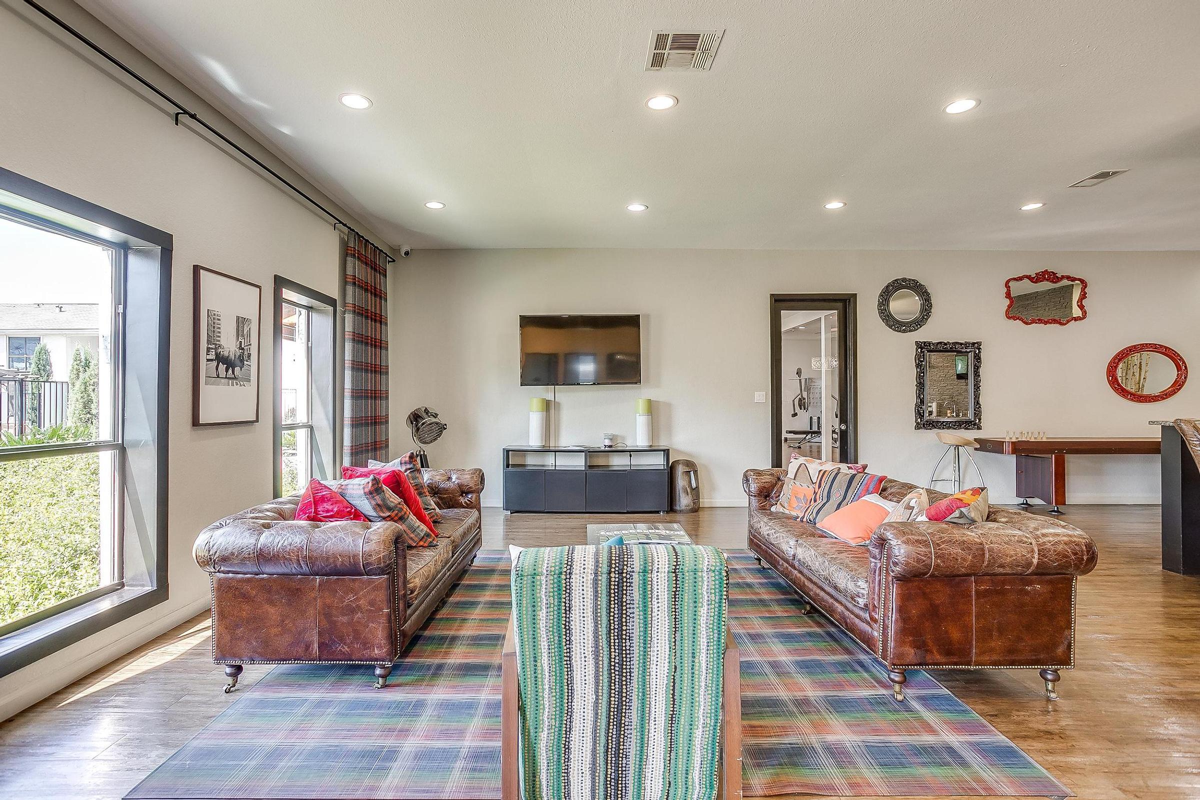 a living room filled with furniture and a large window