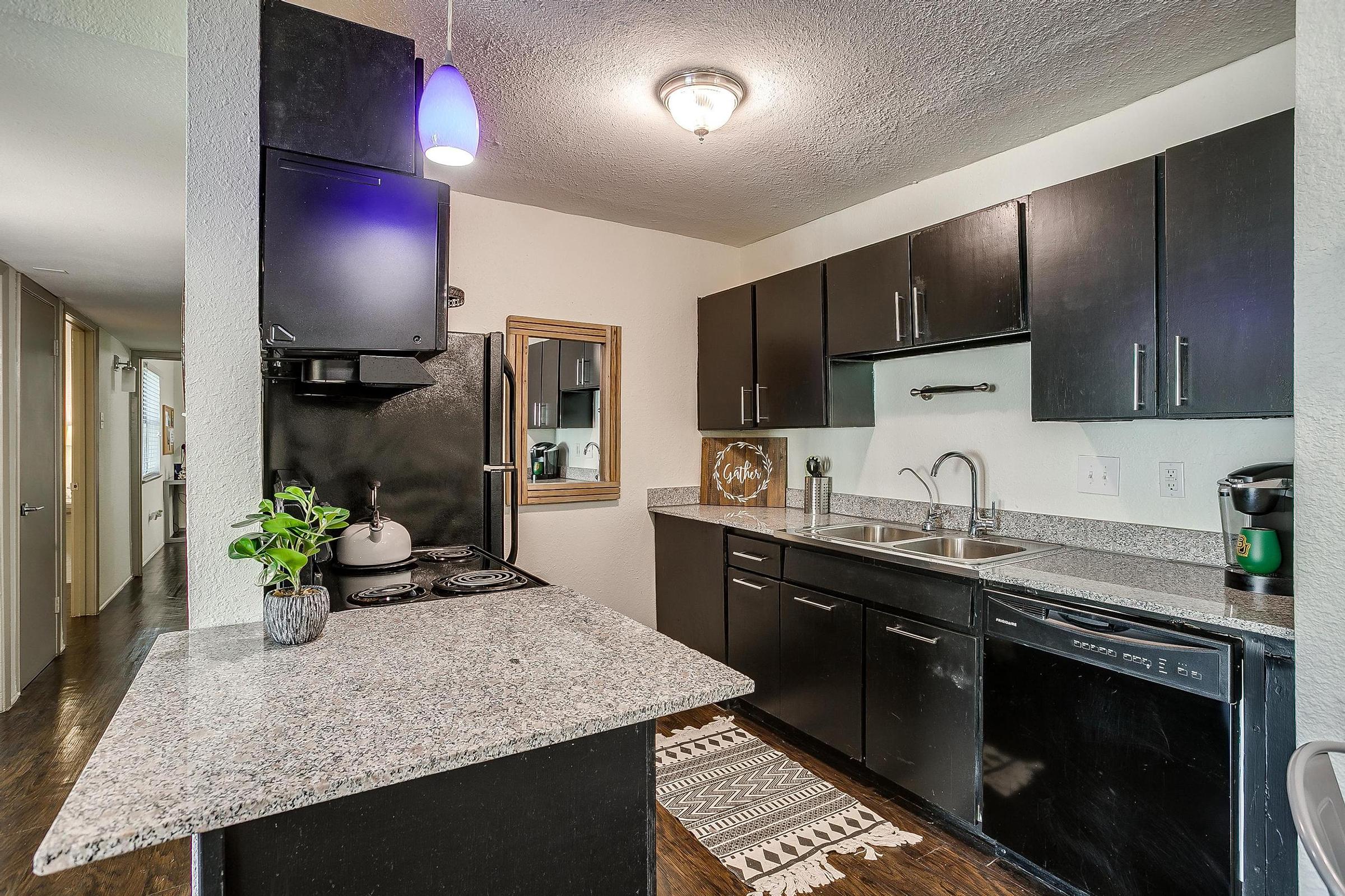 a kitchen with a sink and a mirror