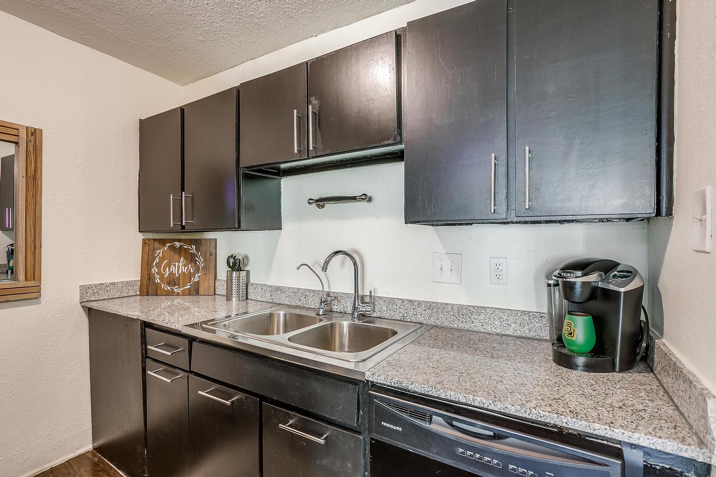 a kitchen with a stainless steel sink