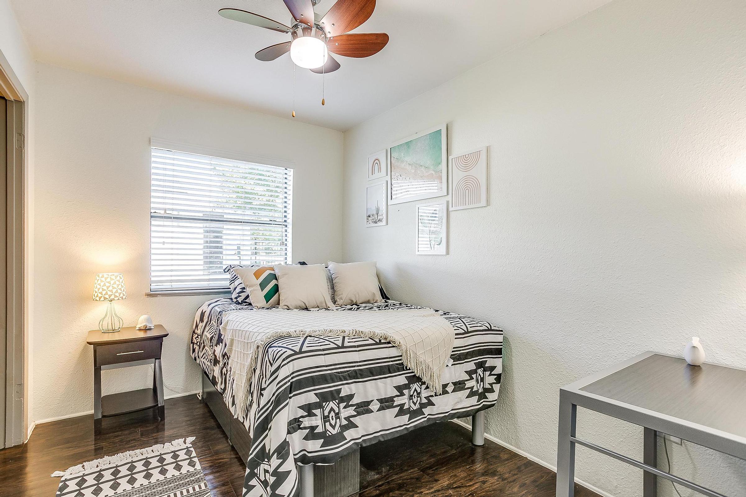 a bedroom with a bed and a chair in a room