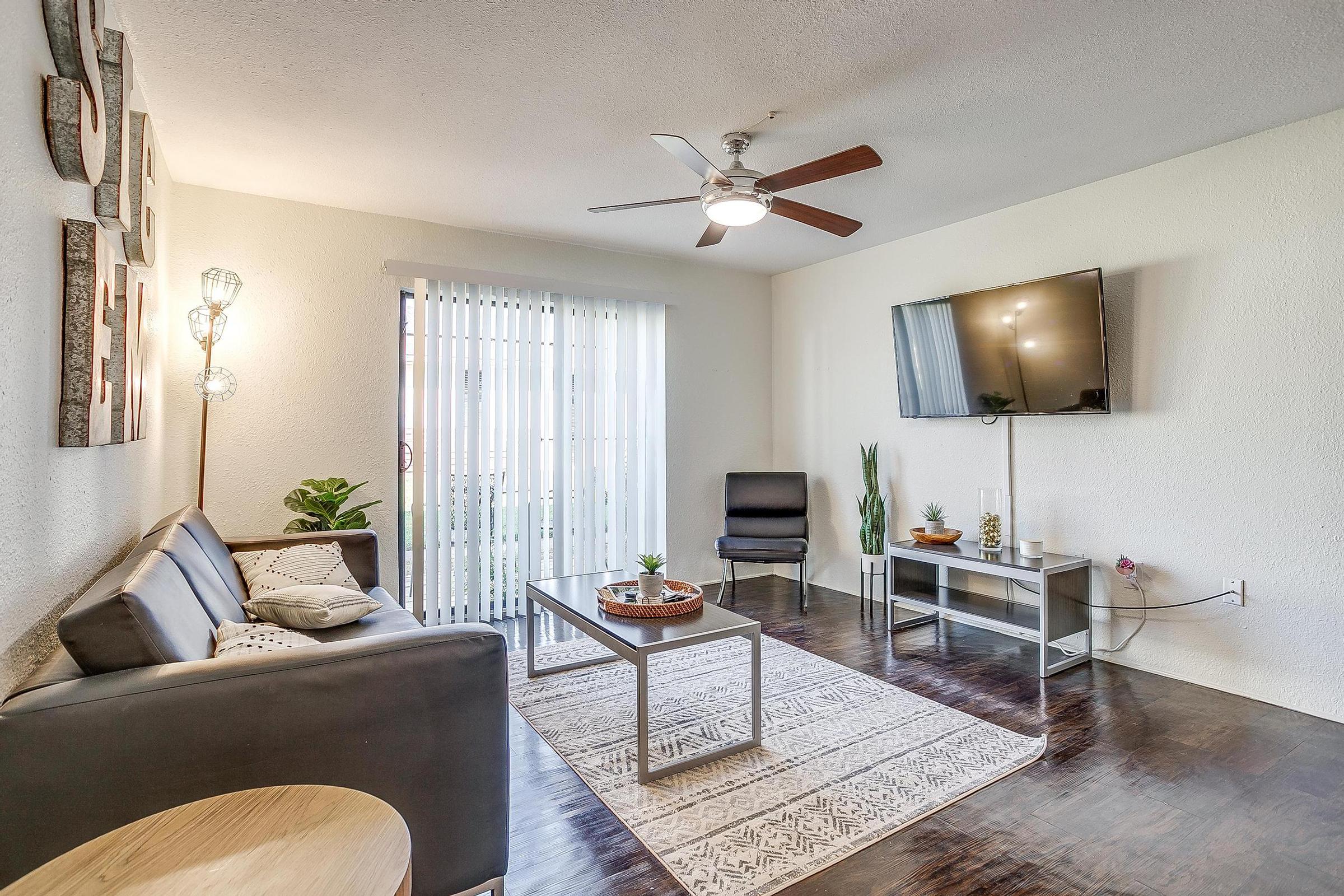 a living room filled with furniture and a large window