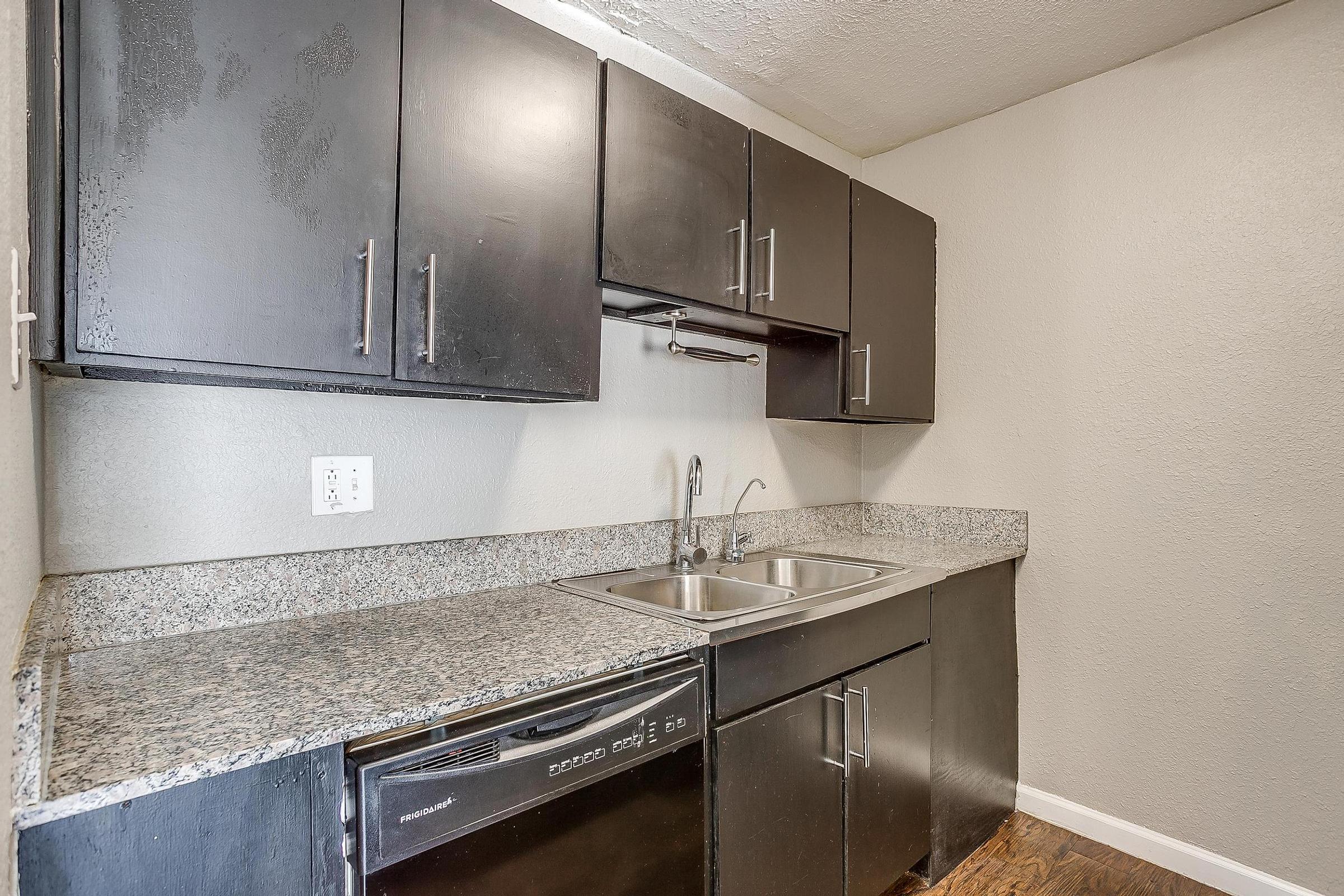 a kitchen with a sink and a mirror