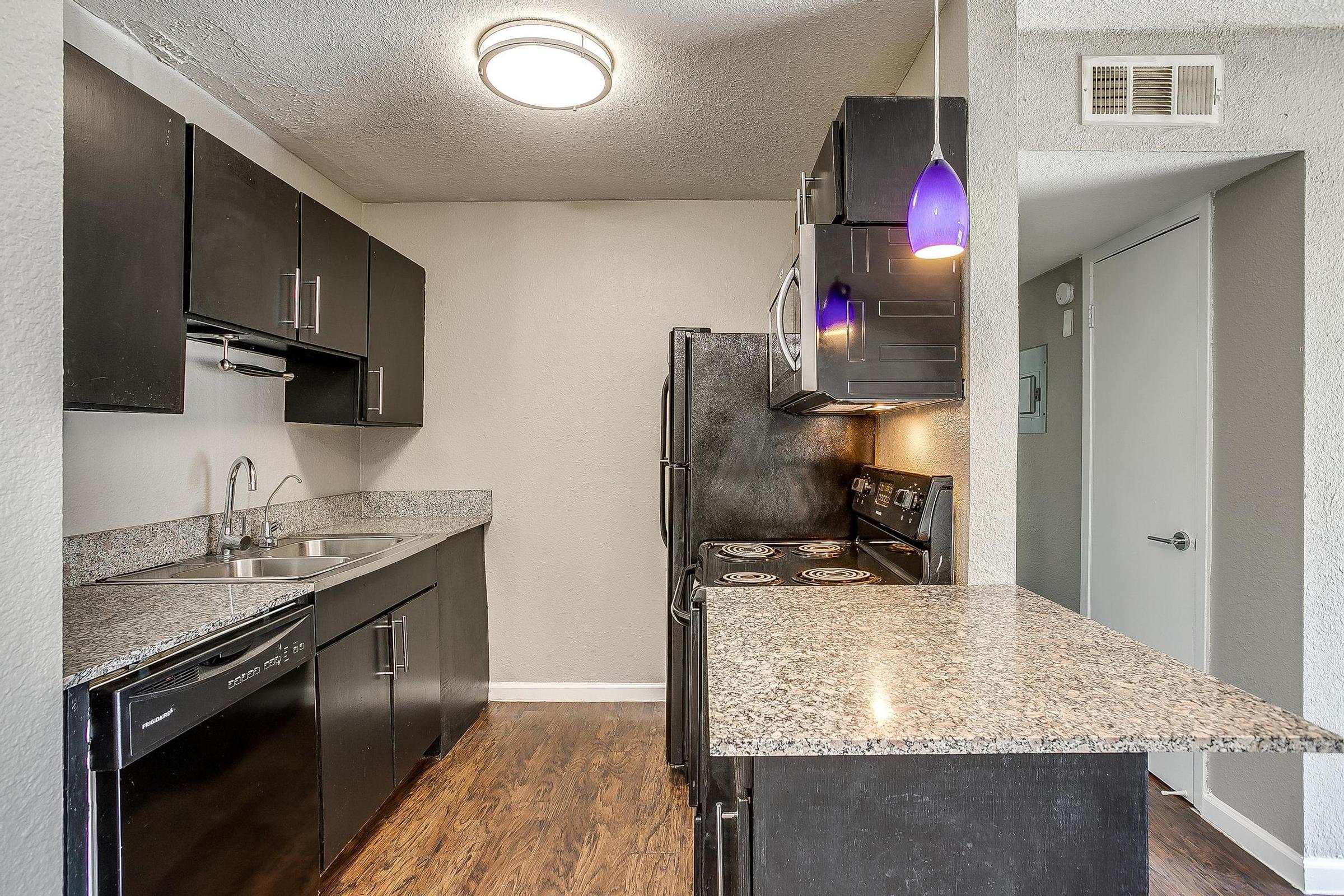 a kitchen with a sink and a mirror