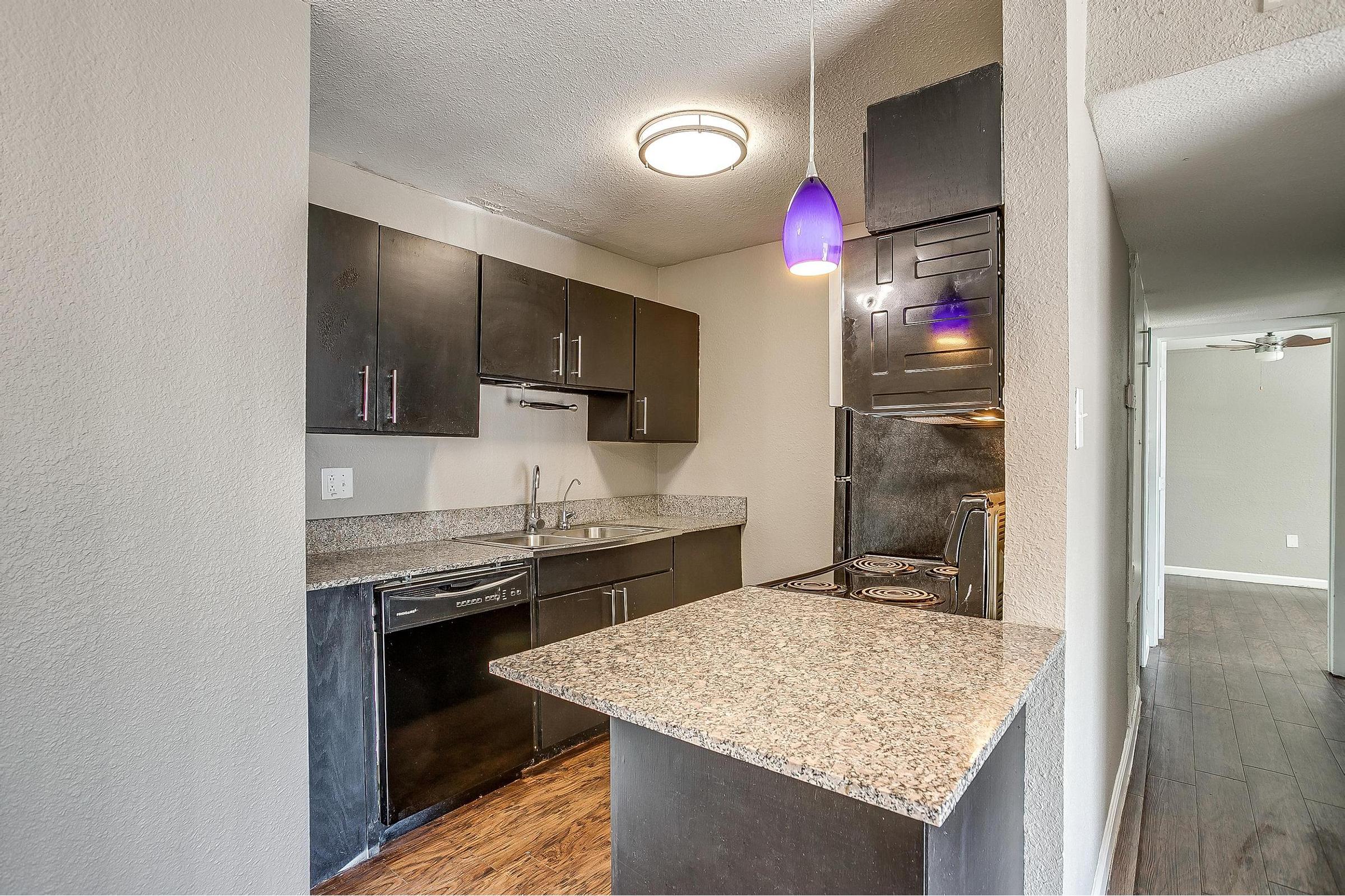 a kitchen with a sink and a mirror