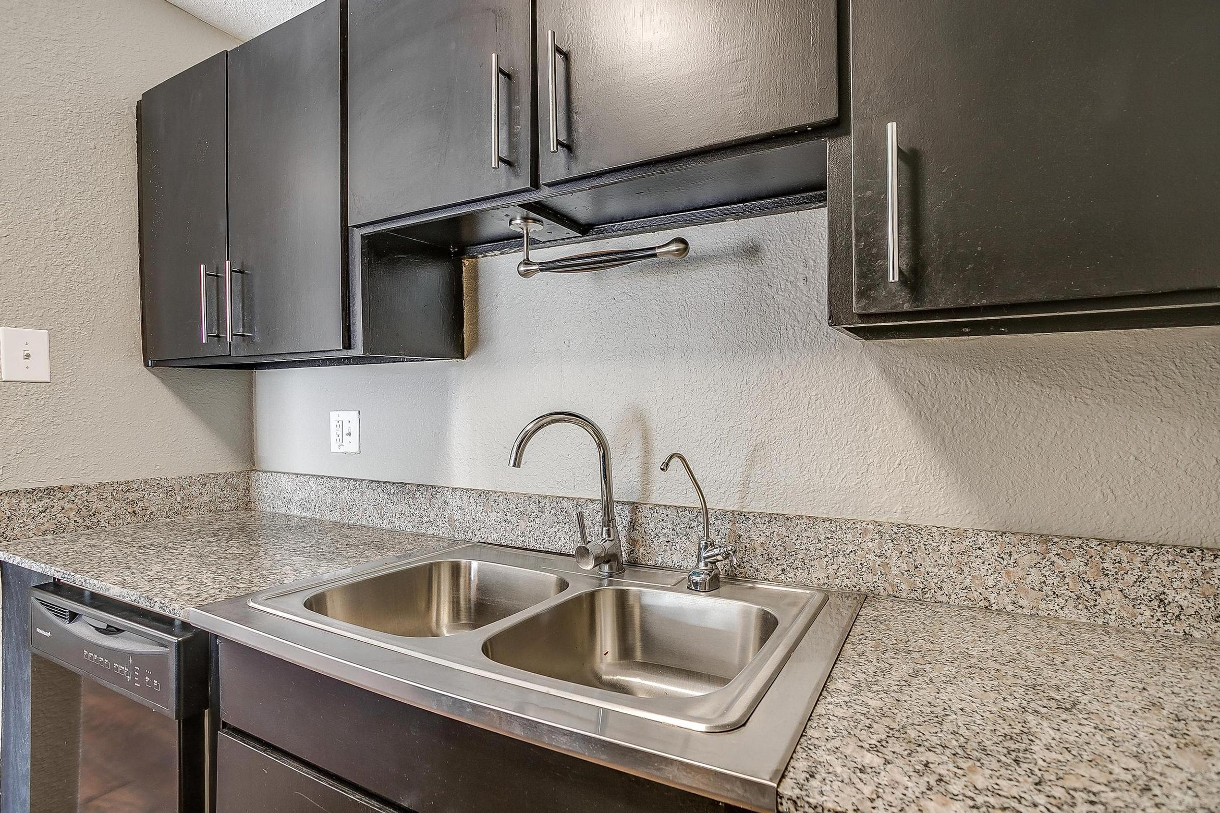 a kitchen with a sink and a mirror