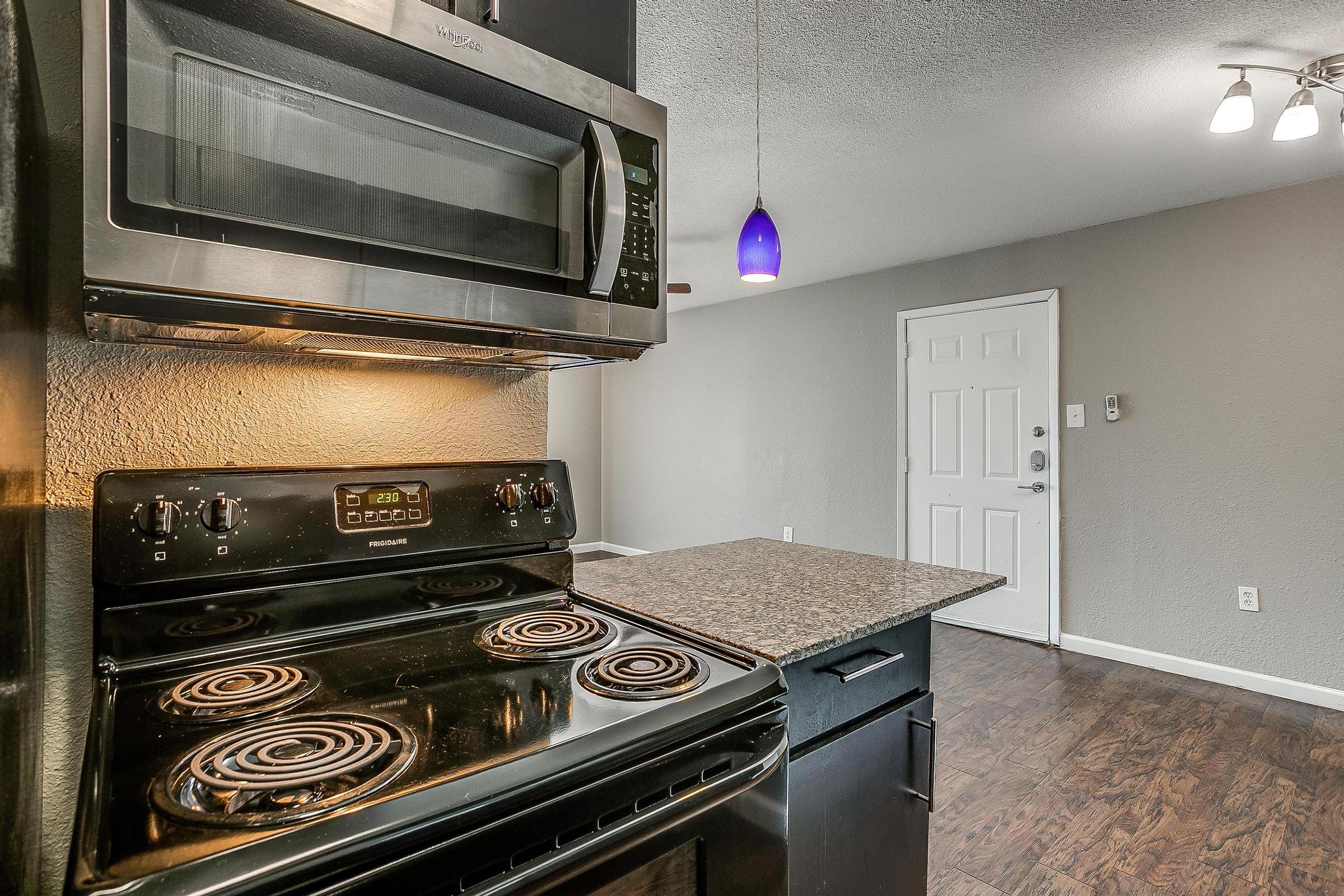 a stove top oven sitting inside of a kitchen