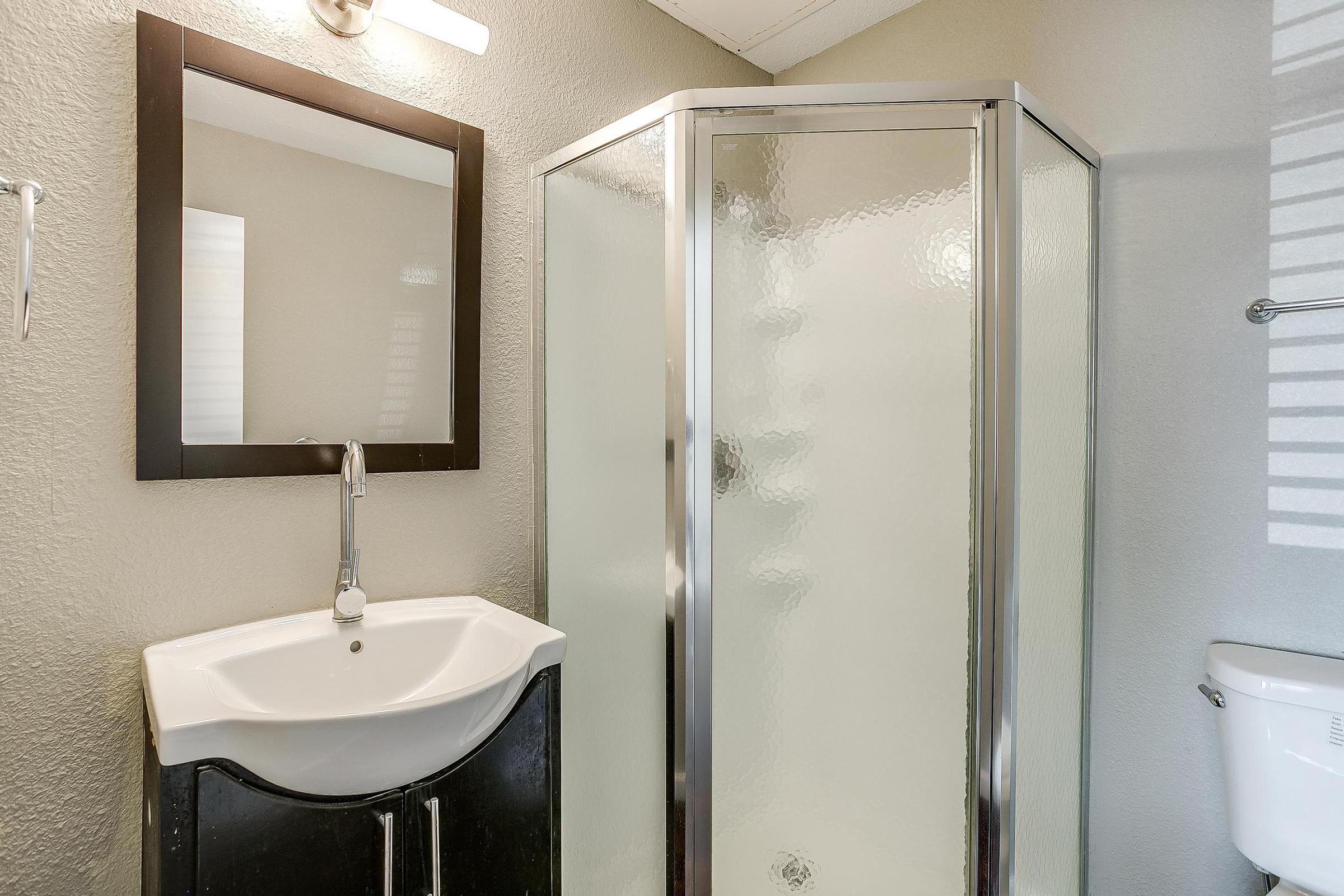 a restroom with a sink and a mirror