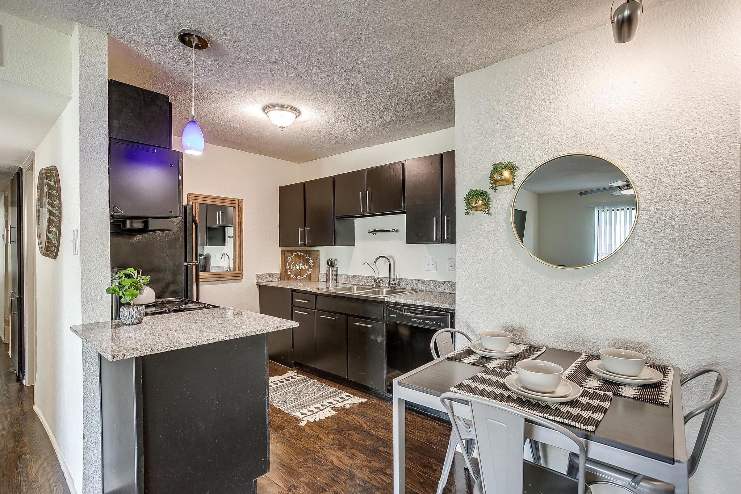 a kitchen with a sink and a mirror