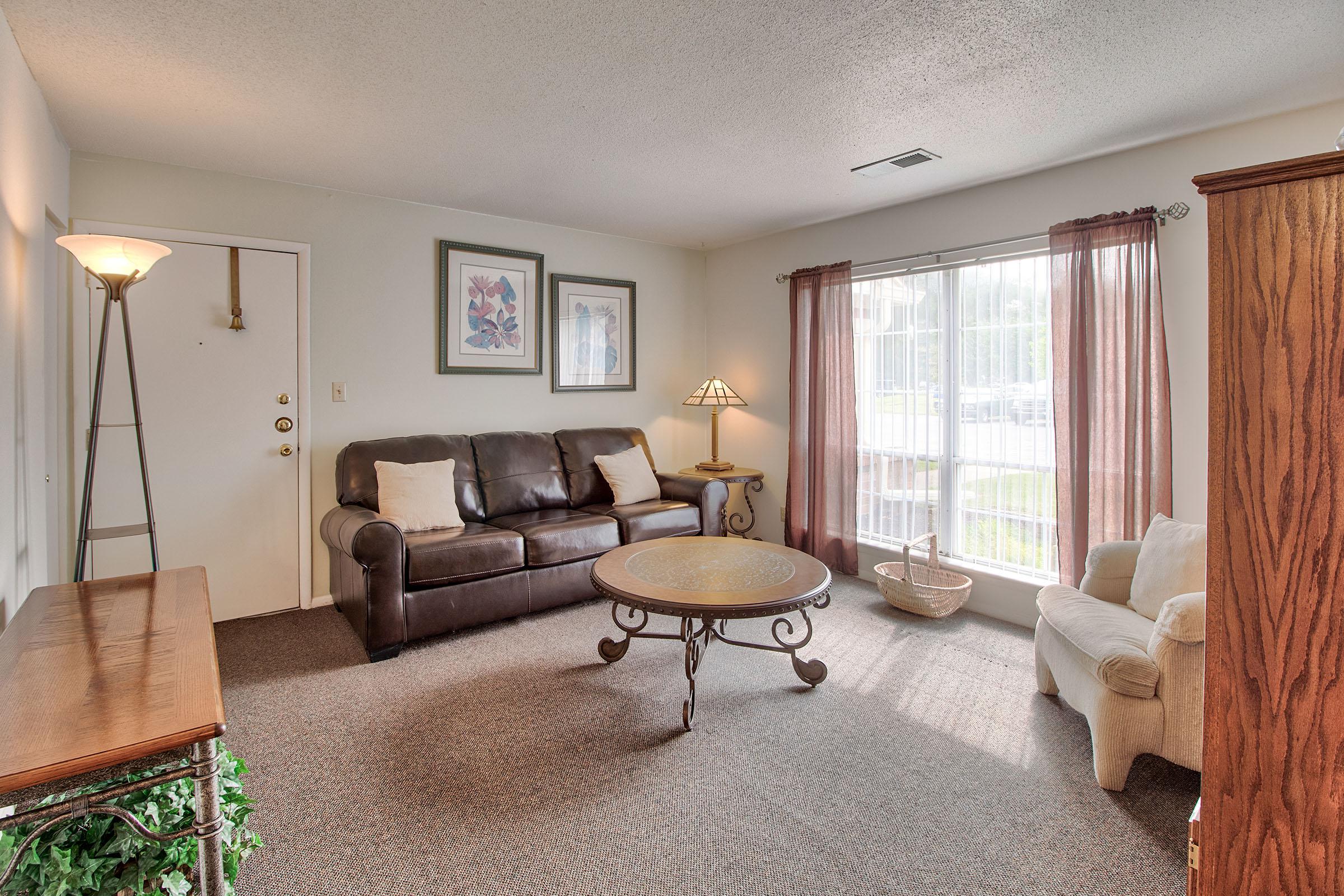 a living room filled with furniture and a flat screen tv